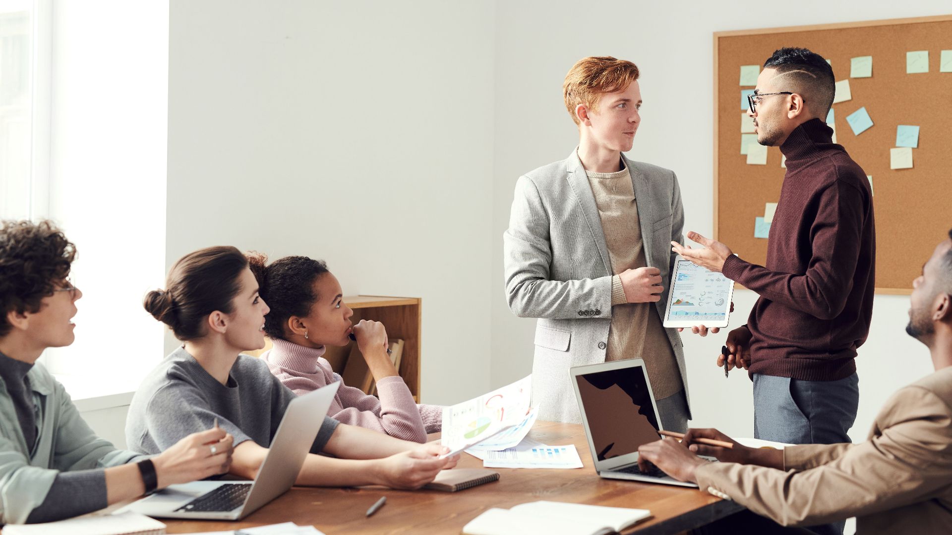 A group of professionals collaborating in a modern office meeting room, exchanging ideas.