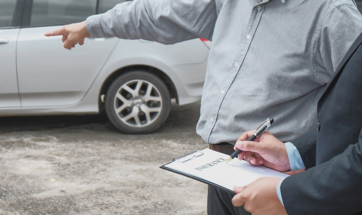 Loss Adjuster Insurance Agent Inspecting Damaged Car. Sales manager giving advice application document considering mortgage loan offer for car insurance