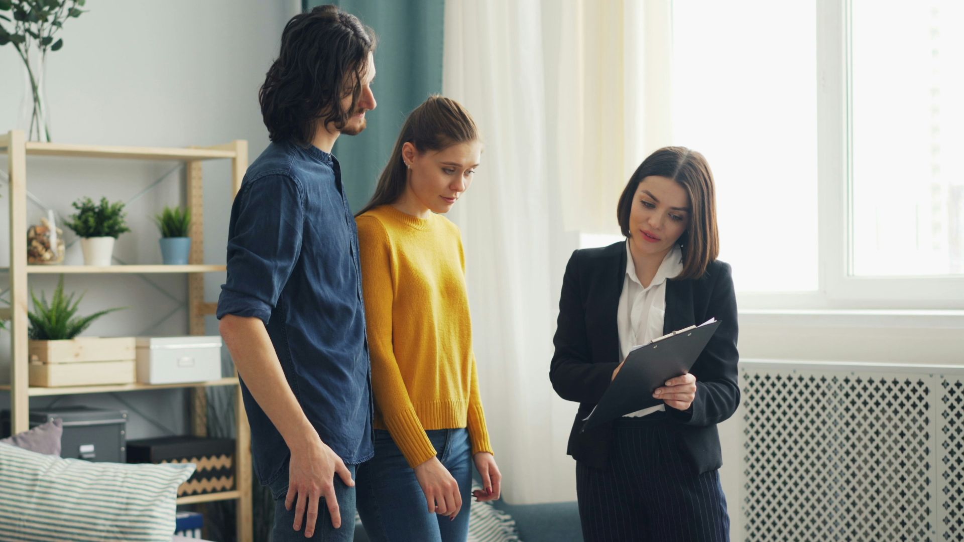 a man and a woman standing in a living room