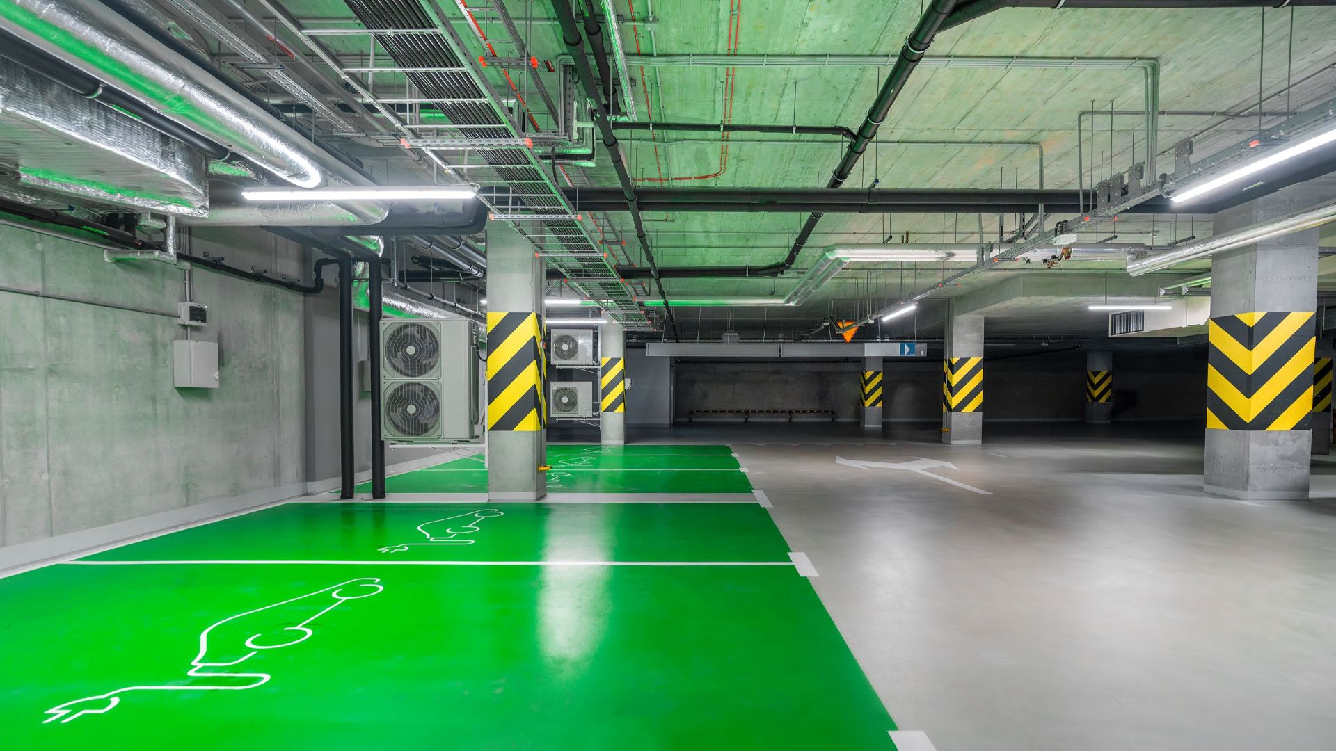 Modern green electric car charging station in an underground parking lot, eco-friendly urban solution.