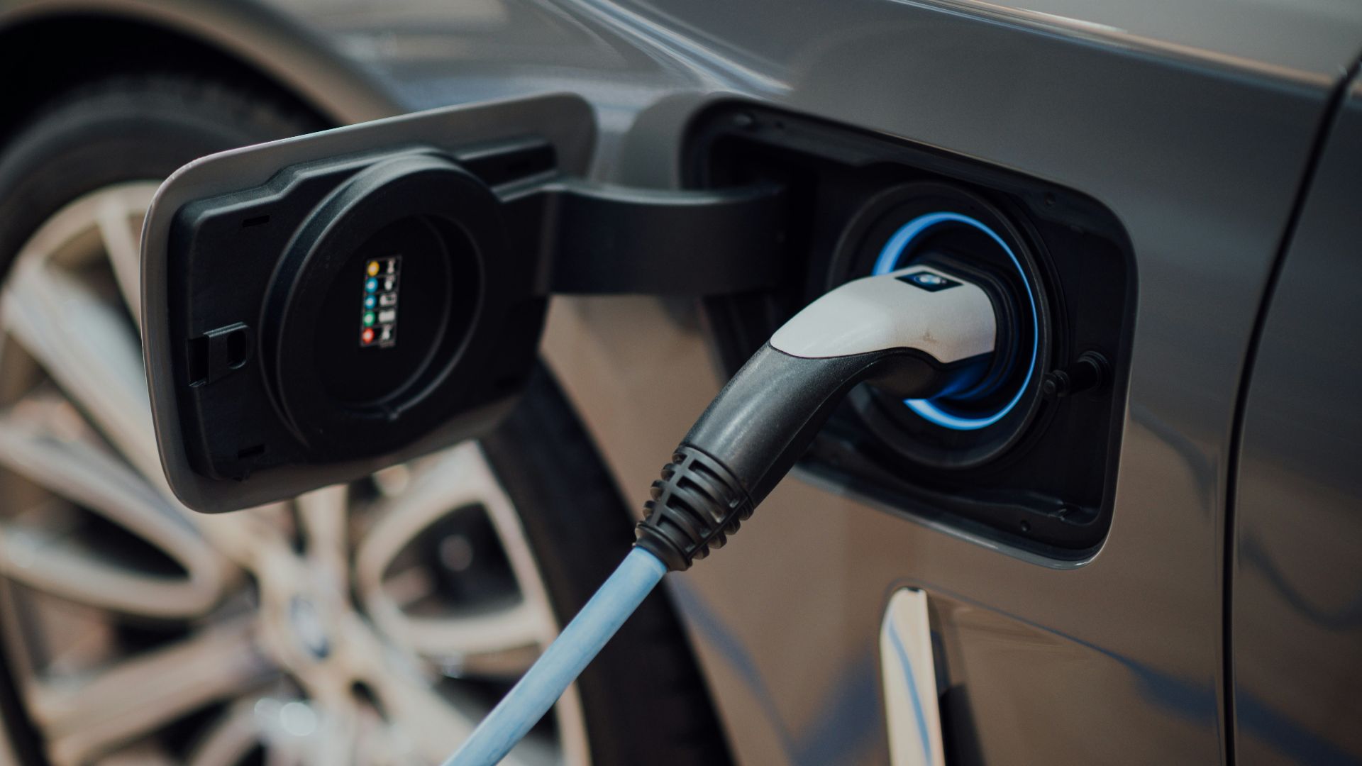 electric vehicle charging cable plugged into car