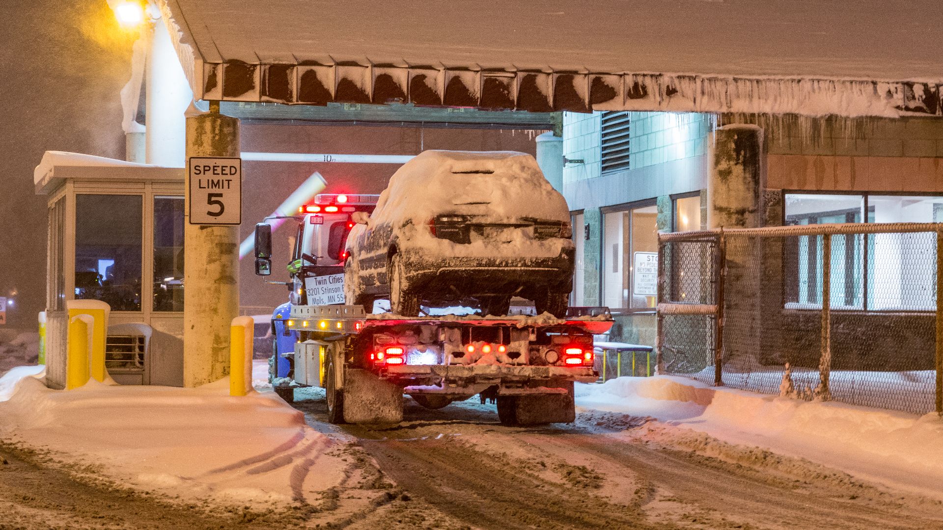 A tow truck brings a vehicle to the Minneapolis City Impound Lot at 51 Colfax Ave N in North Minneapolis, during a snow emergency. February 2-3, 2016.