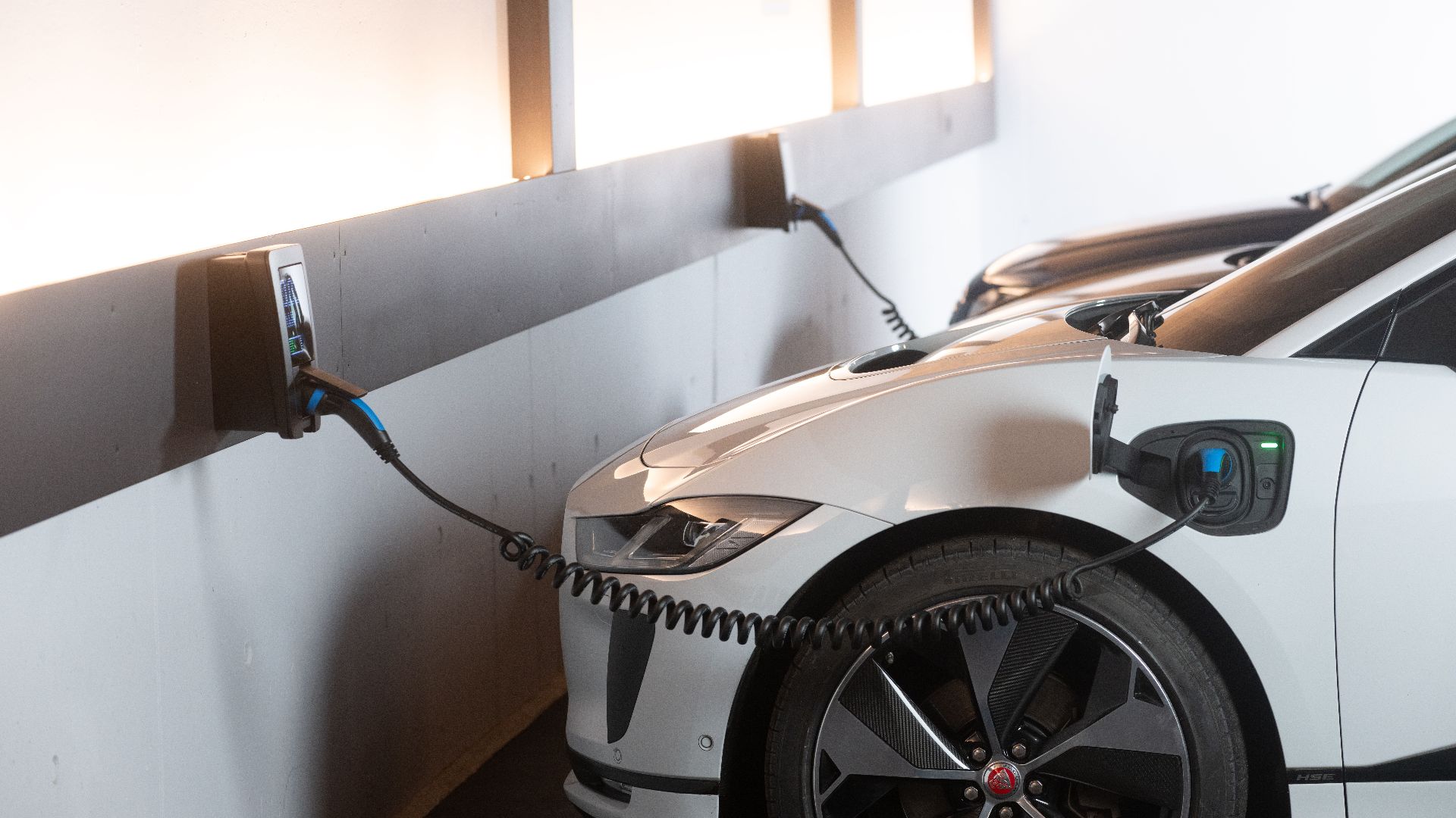 Electric car charging in a modern indoor station promoting sustainability and energy efficiency.
