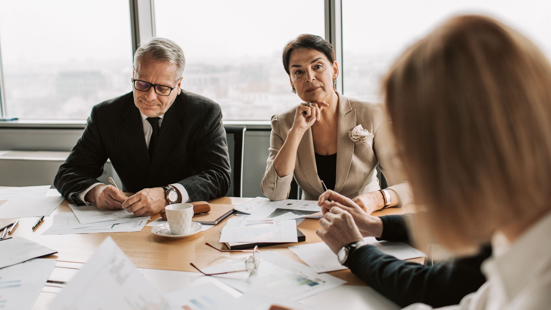 Business professionals in discussion during a meeting in a modern office setting.