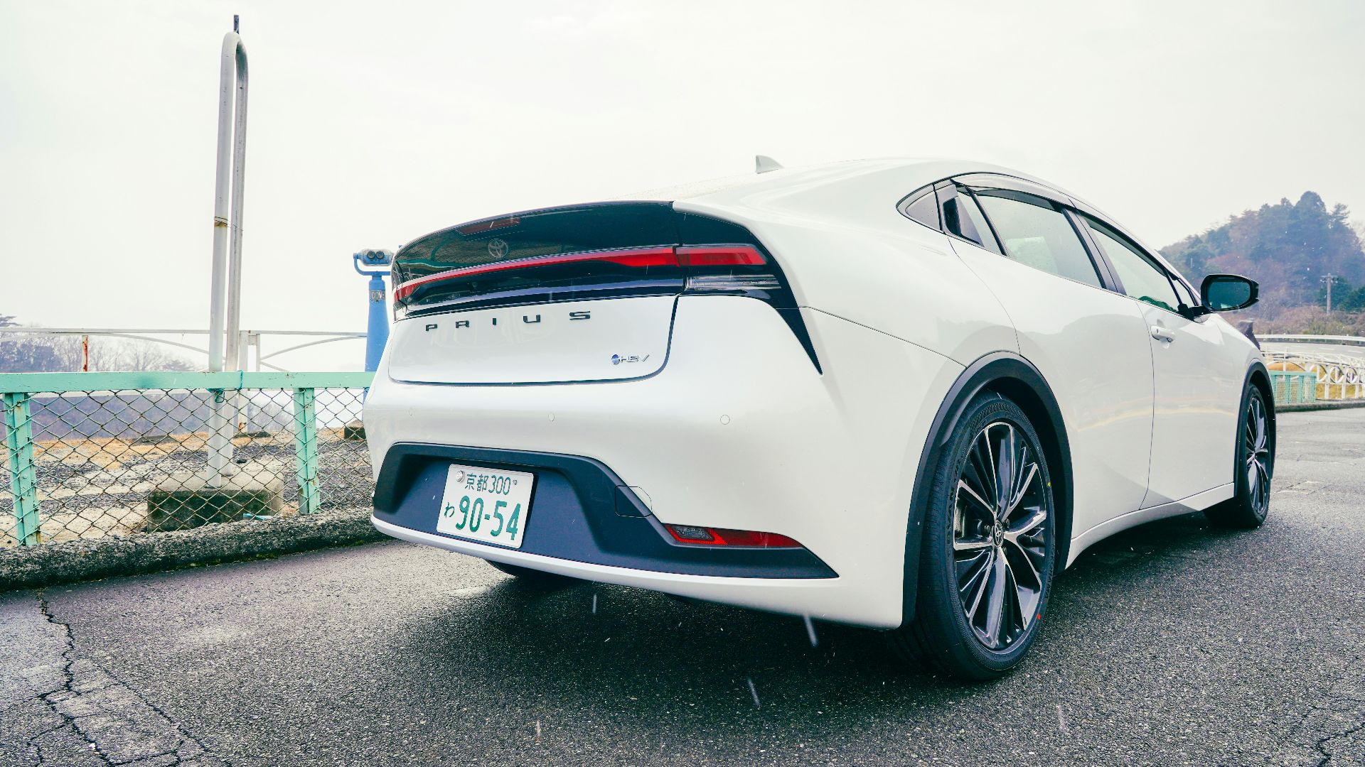 A white car parked on the side of the road