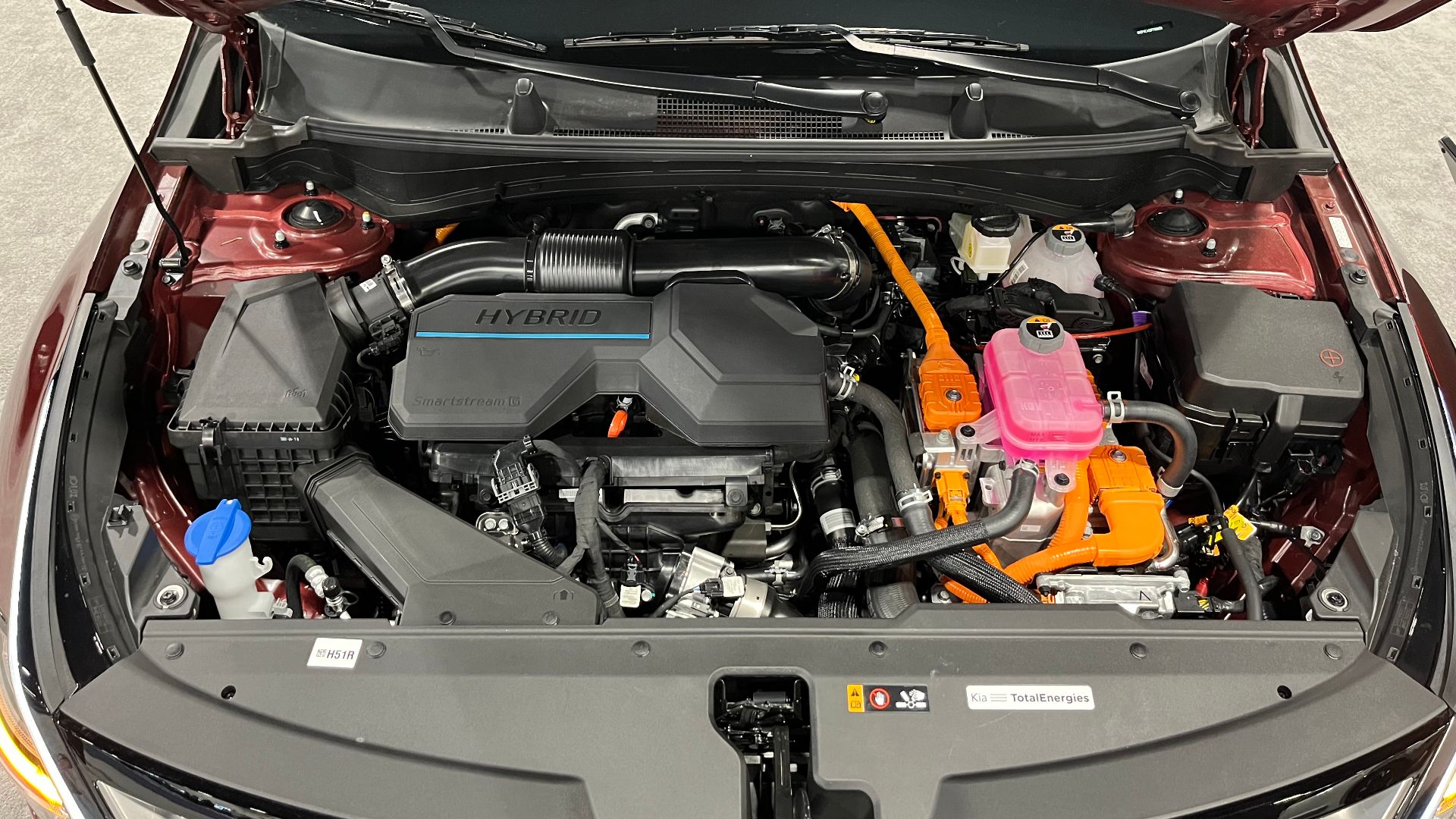 The engine bay of a 2023 Kia Sportage Hybrid SX Prestige AWD at the 2023 Denver Auto Show.