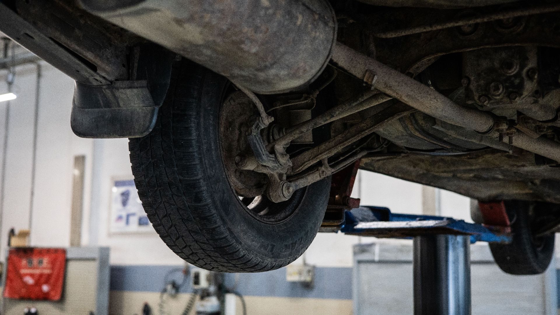 Close-up of car's undercarriage in a service station for repair and maintenance.
