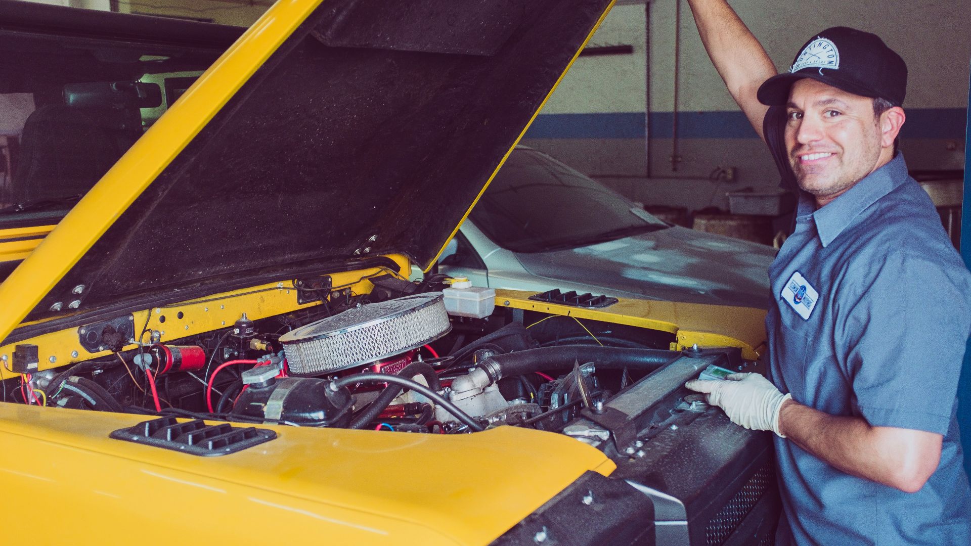 man holding open-wide car trunk