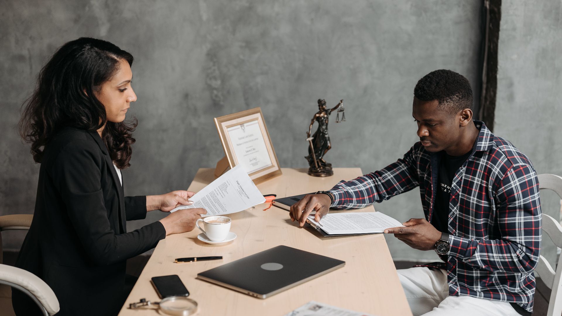 Business professionals discussing documents in a modern office setting.