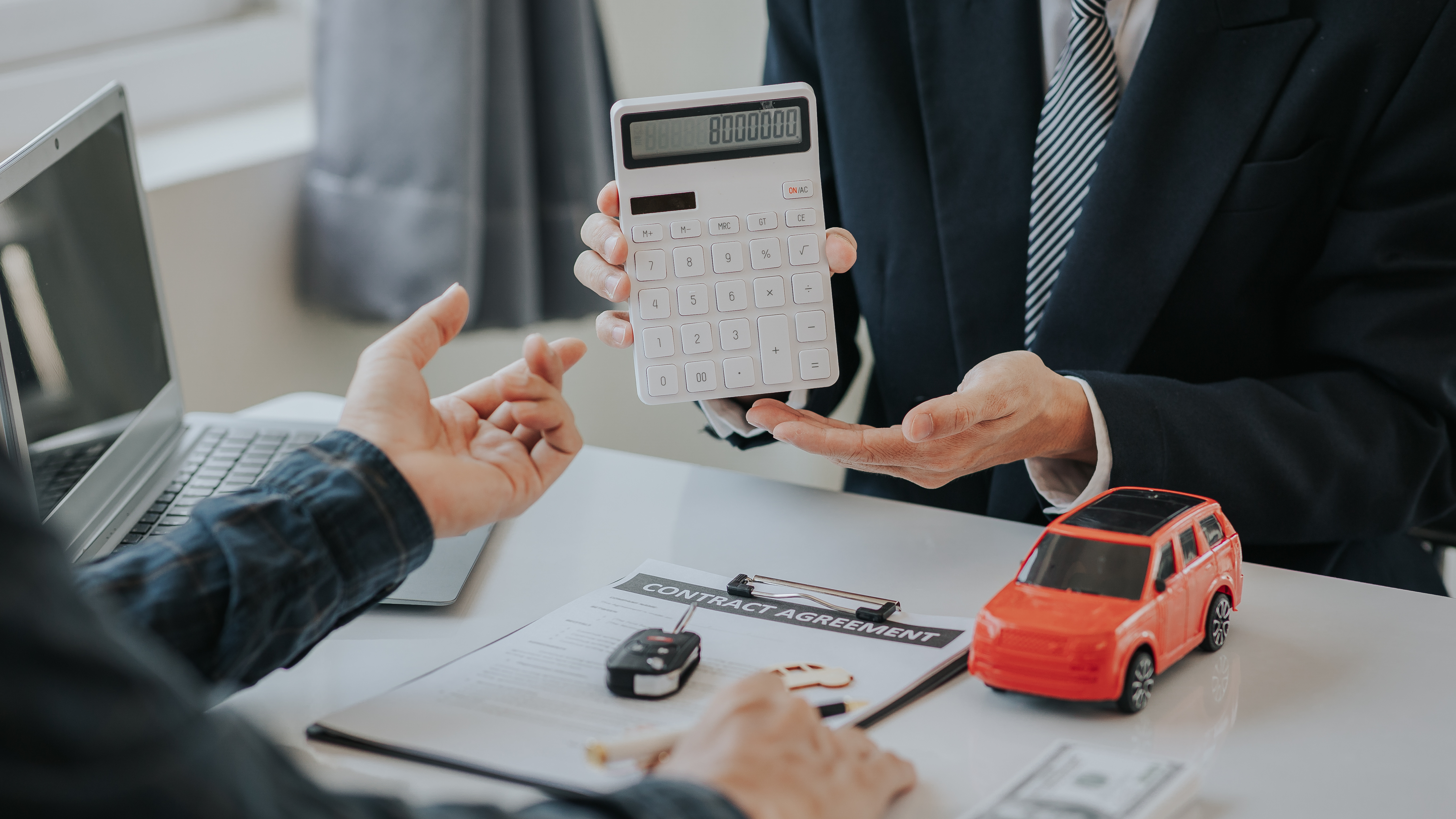A person going over the purchase details of a new car.
