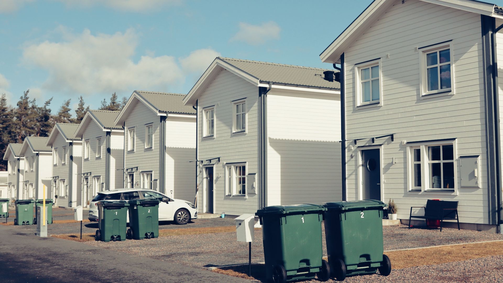 Street view of modern suburban houses in Jönköping, Sweden with clear blue sky.