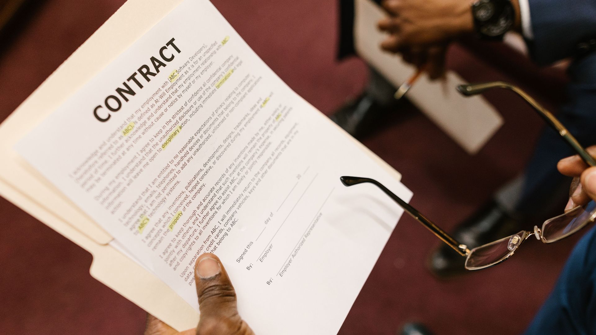 Close-up of hands holding a contract, focus on business agreement discussion.