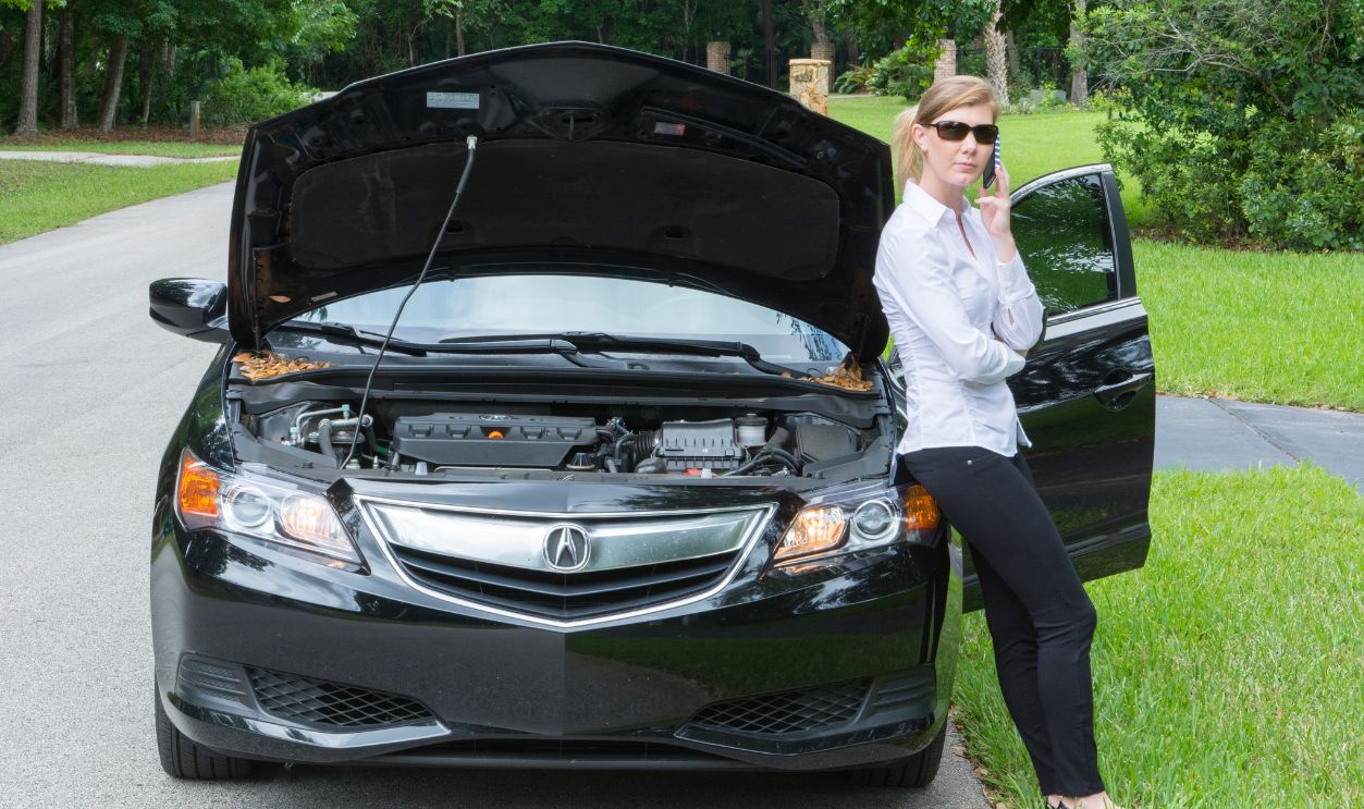 Young woman with car broken down 629538275