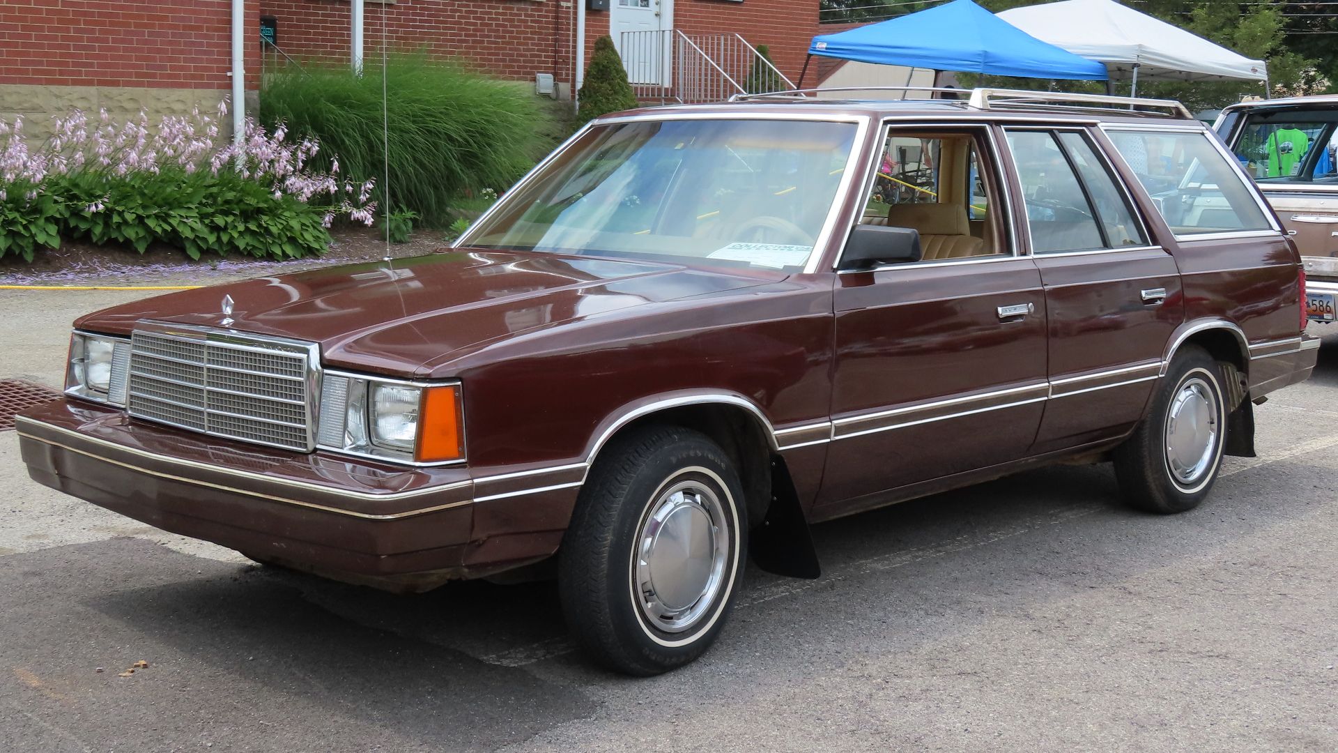 1982 Plymouth Reliant Custom wagon photographed at the July 15, 2023 International Station Wagon Club meet in Butler, Pennsylvania. Finished in Morocco Red.