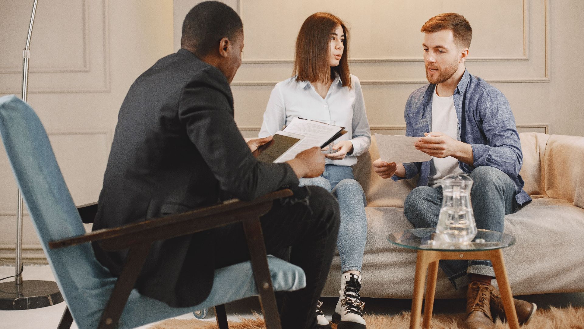 A counseling session with a diverse group of adults discussing issues in a cozy setting.