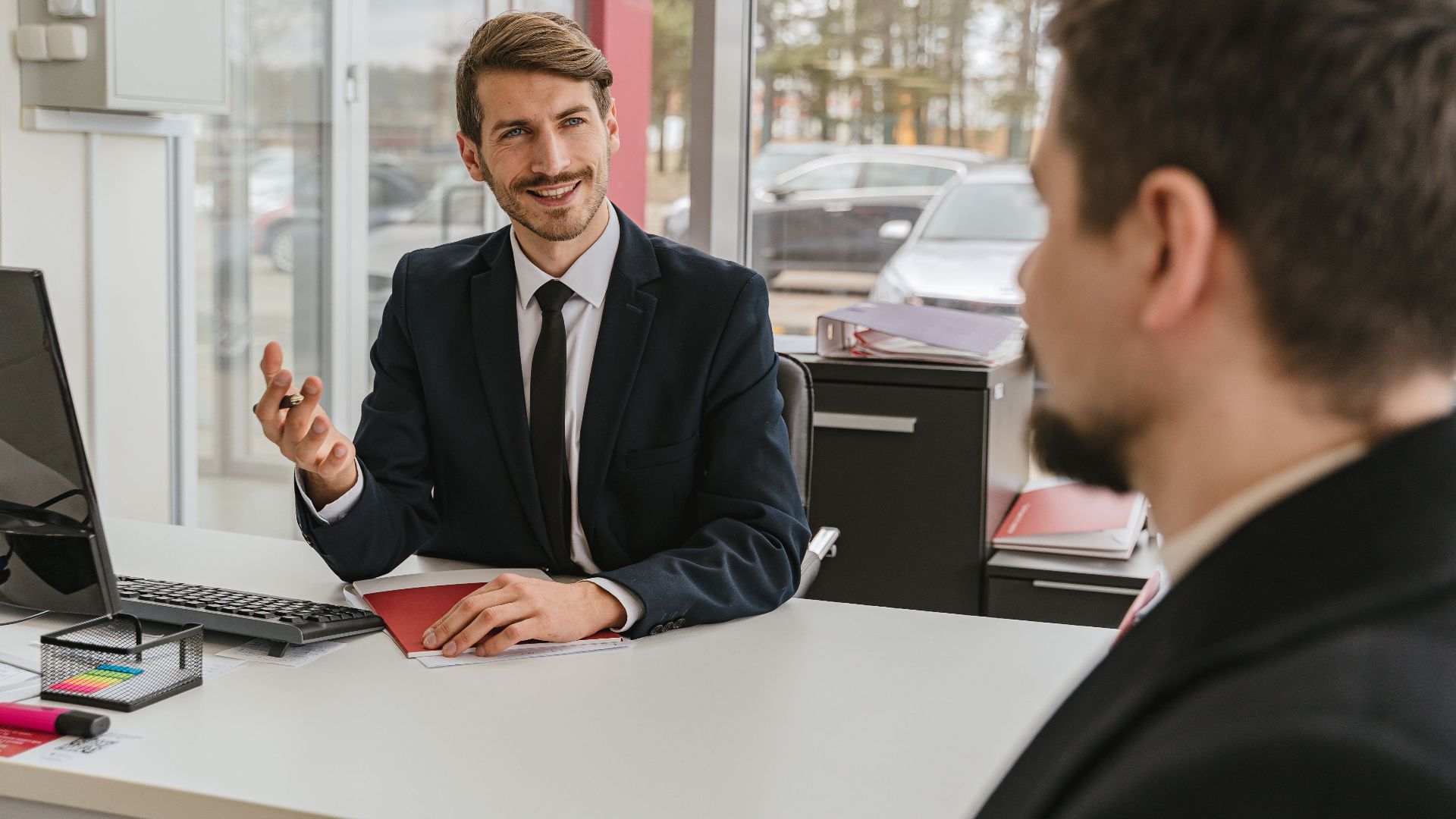 Two businessmen having a conversation in a modern office setting.