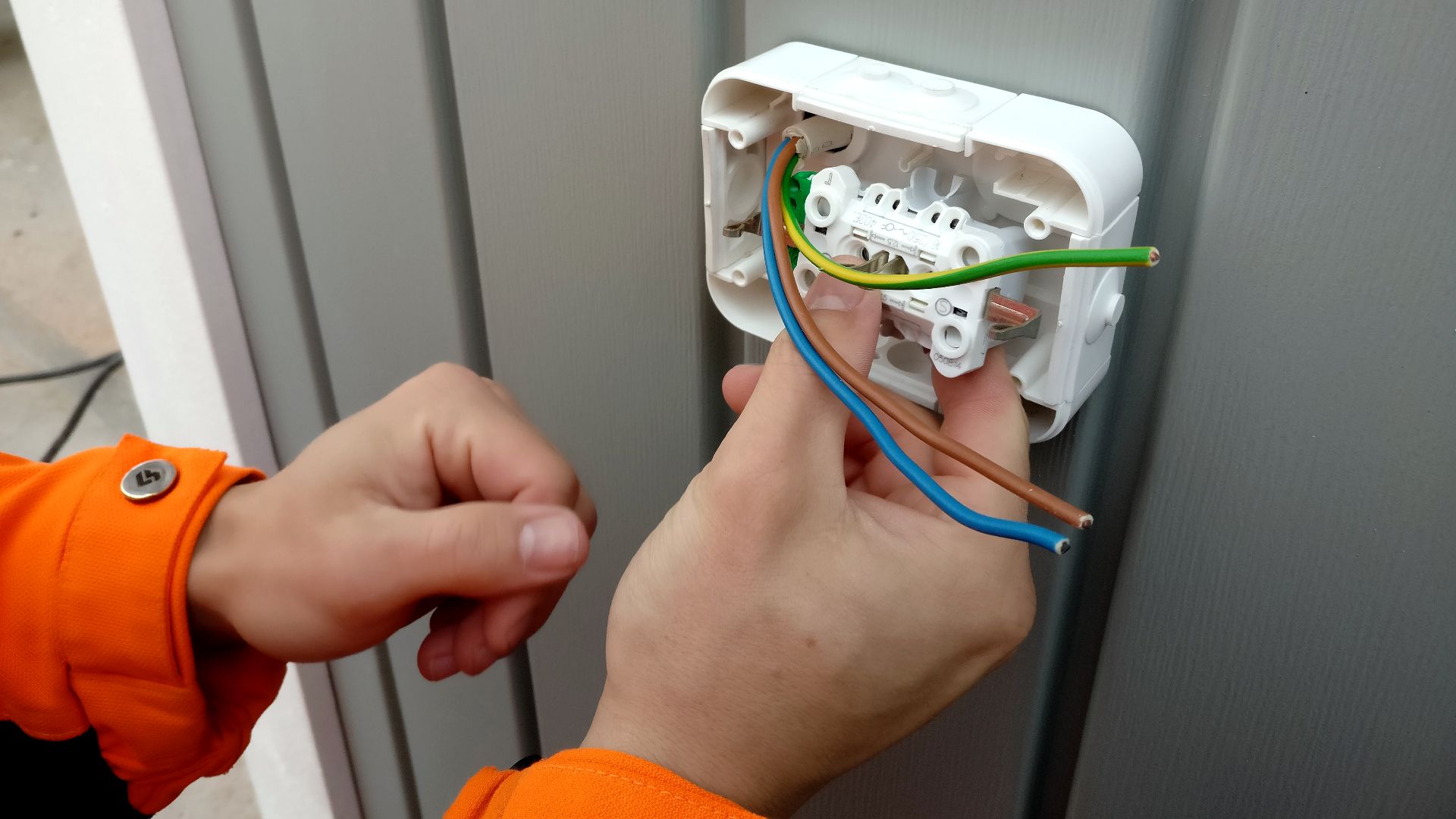 Electrician installing socket.