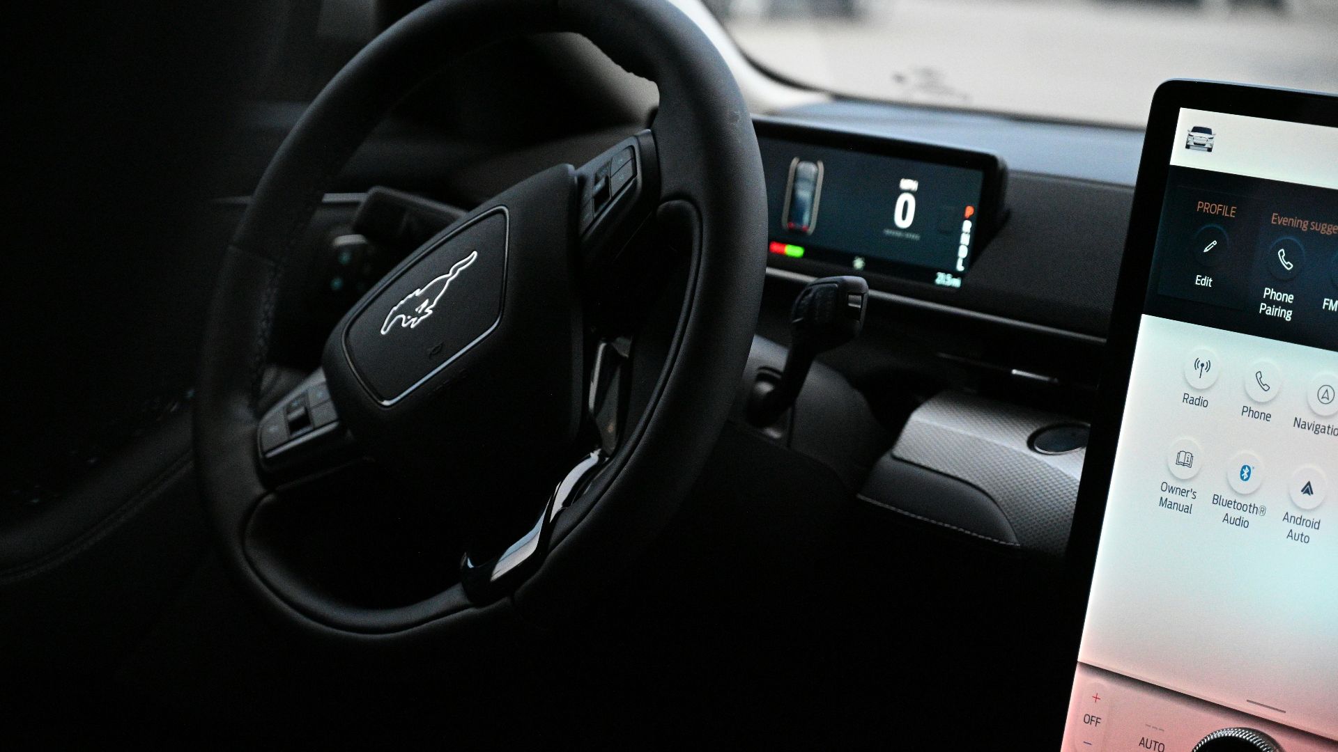 a car dashboard with a touch screen and a steering wheel