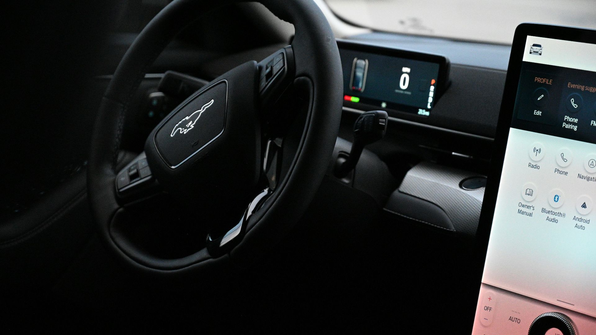 a car dashboard with a touch screen and a steering wheel