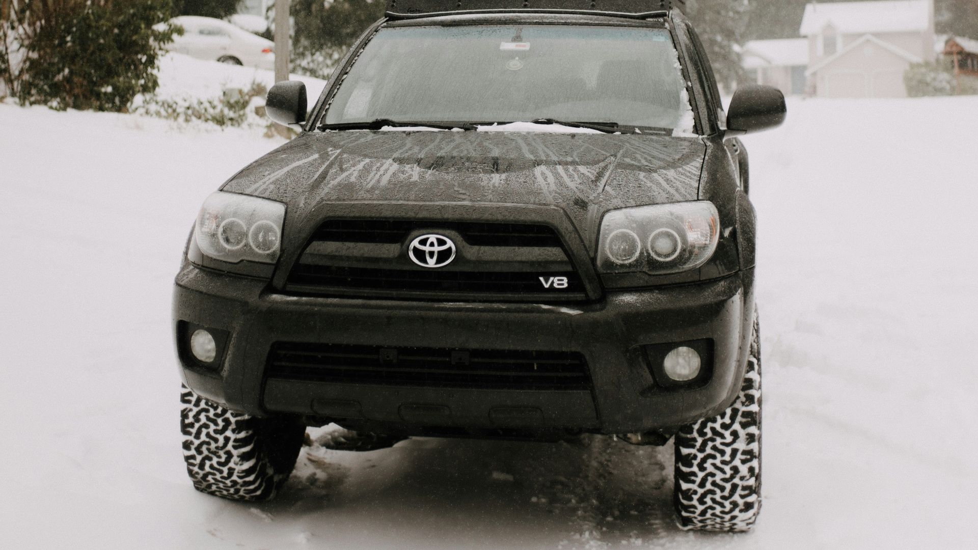 black car on snow covered road during daytime