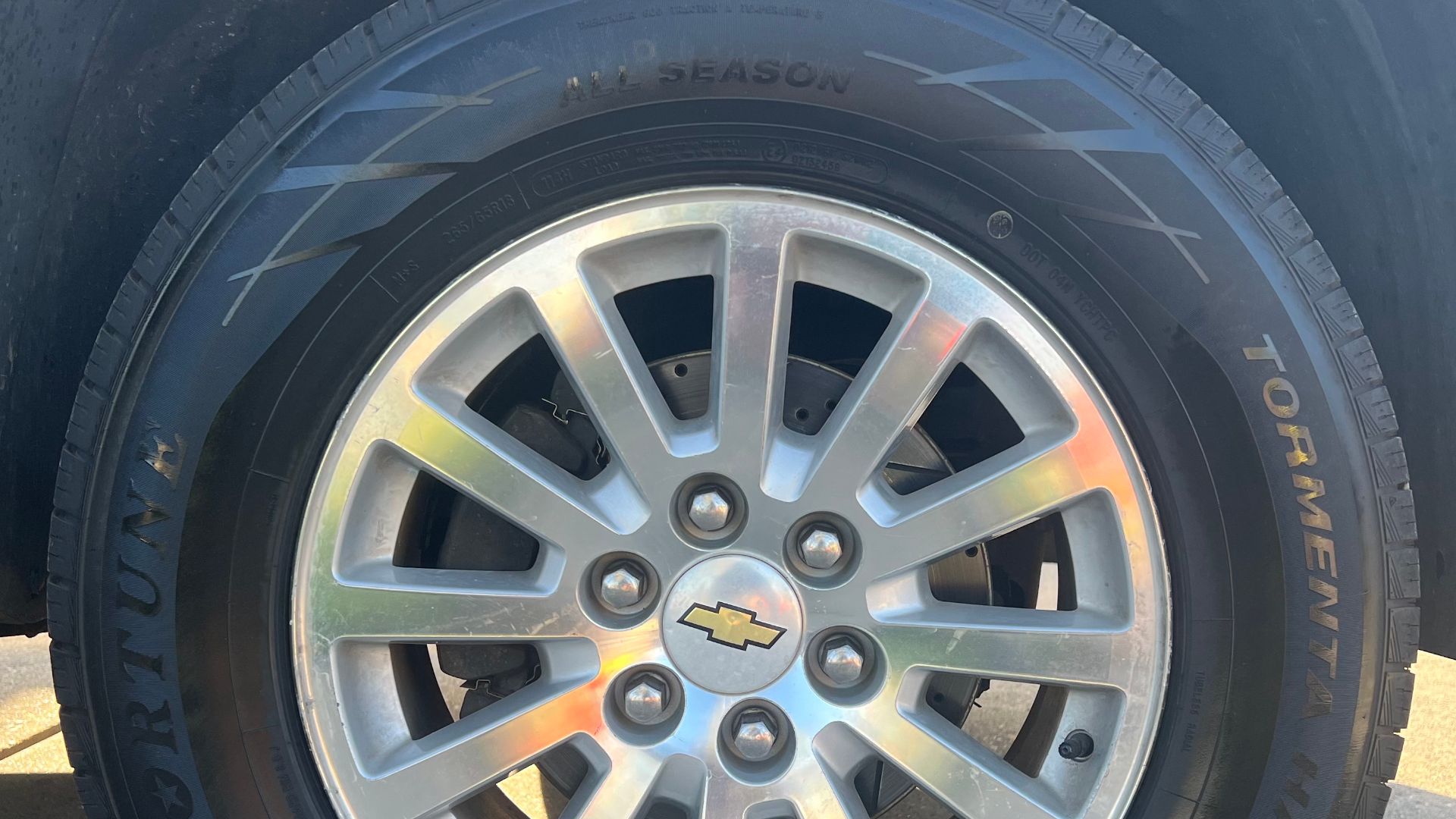 A Chevrolet wheel with a Fortune Tormenta H/T All Season tire.
