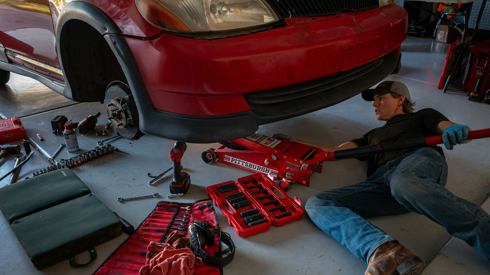 a man working on a car in a garage