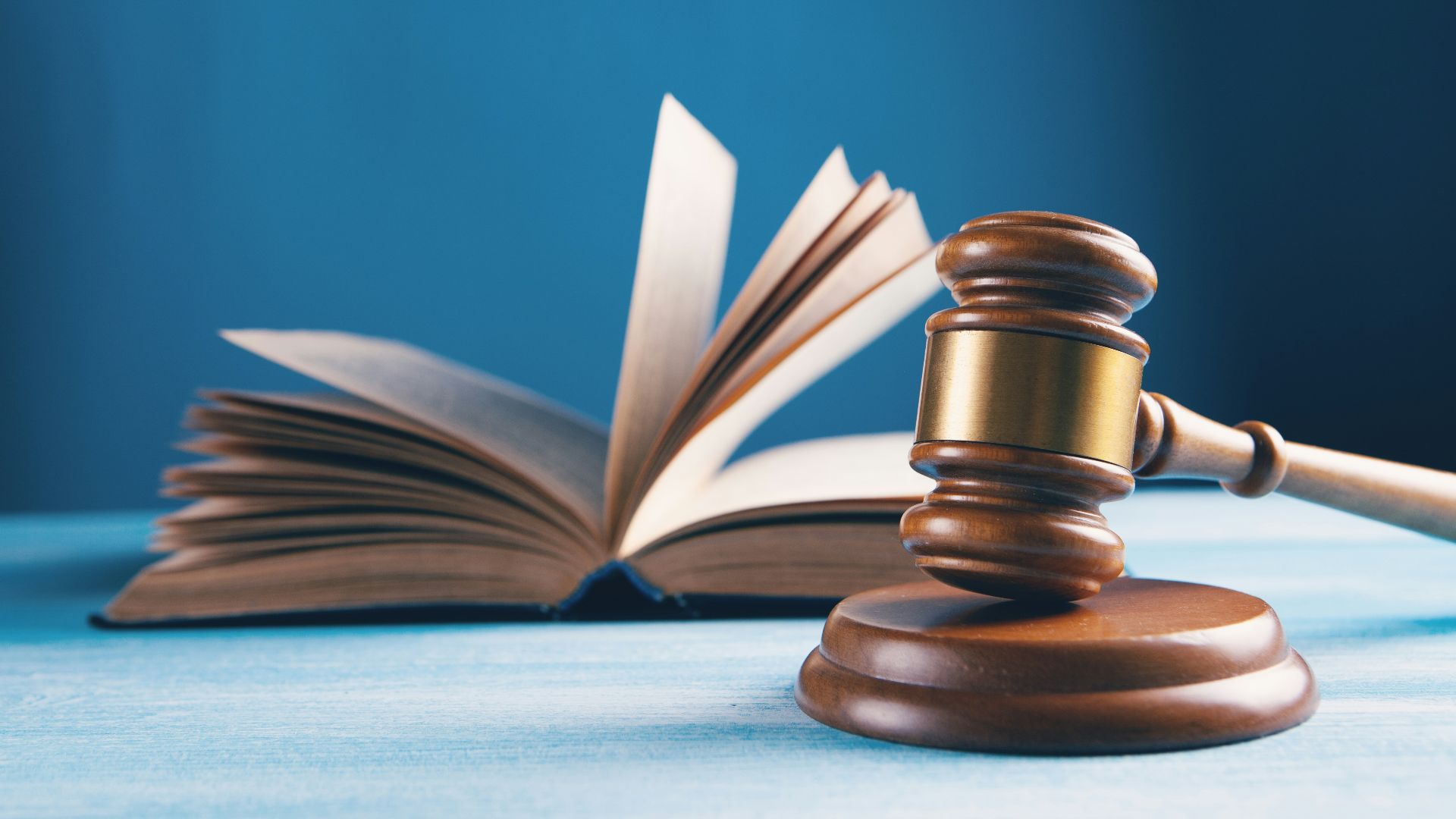 judges gavel and open book on table