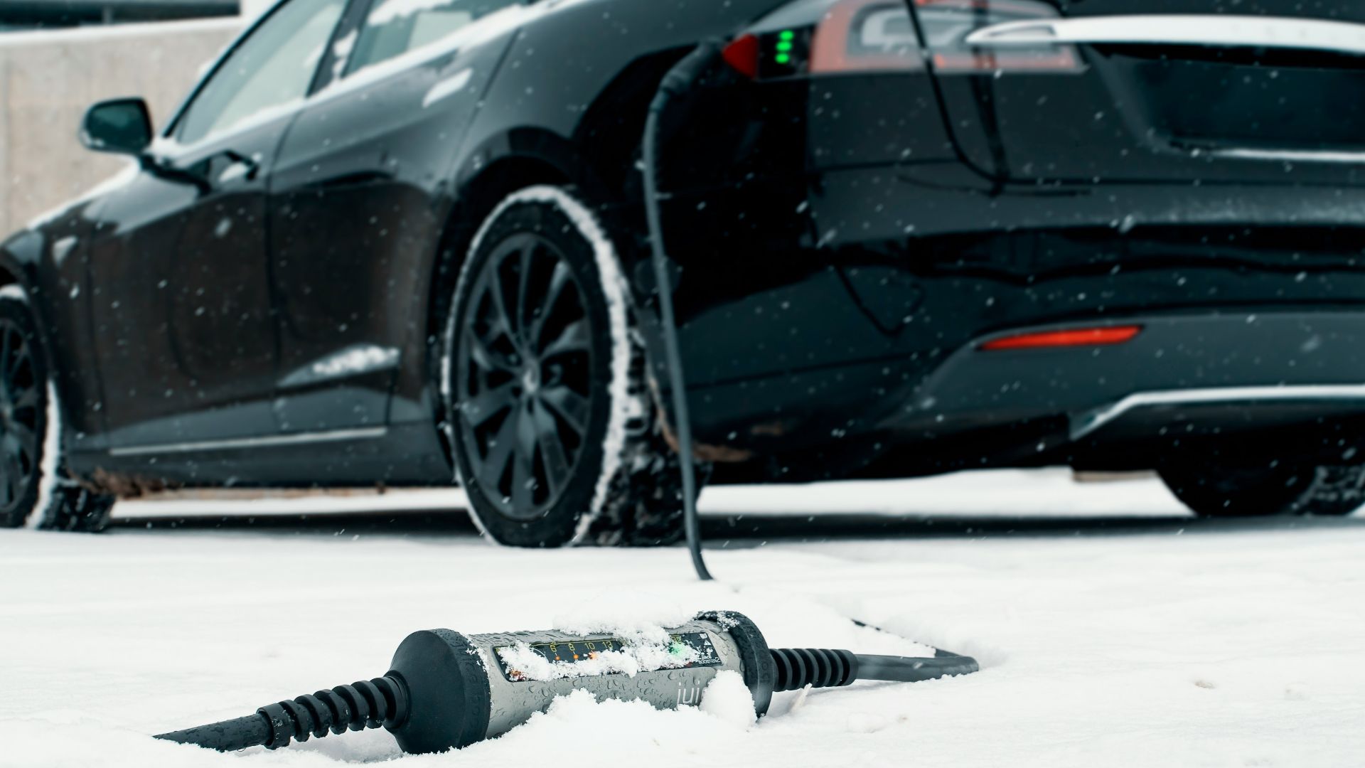 a car is parked in the snow next to a screwdriver