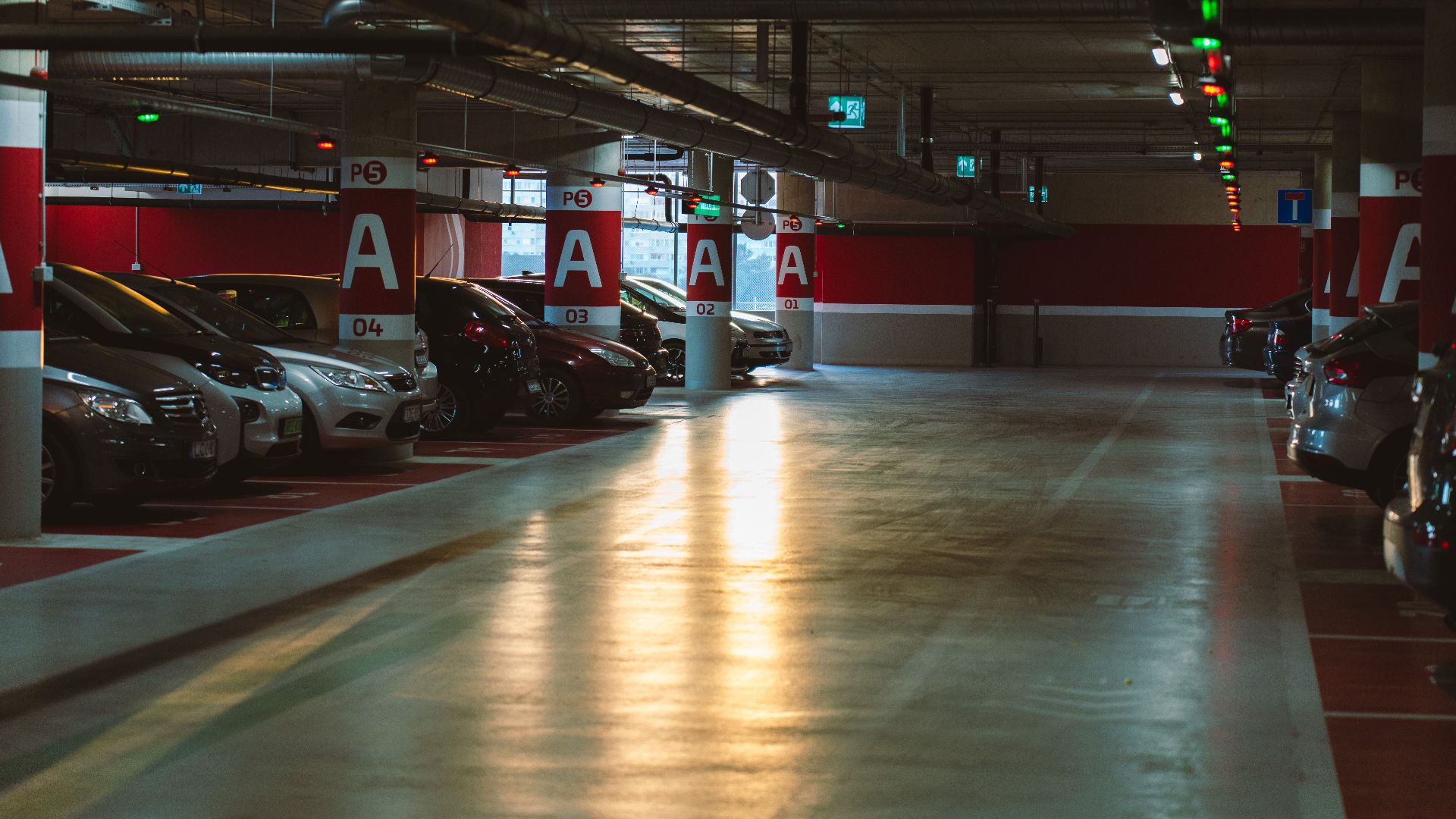 Explore a well-lit underground parking garage in Budapest, showcasing urban architecture and modern facilities.