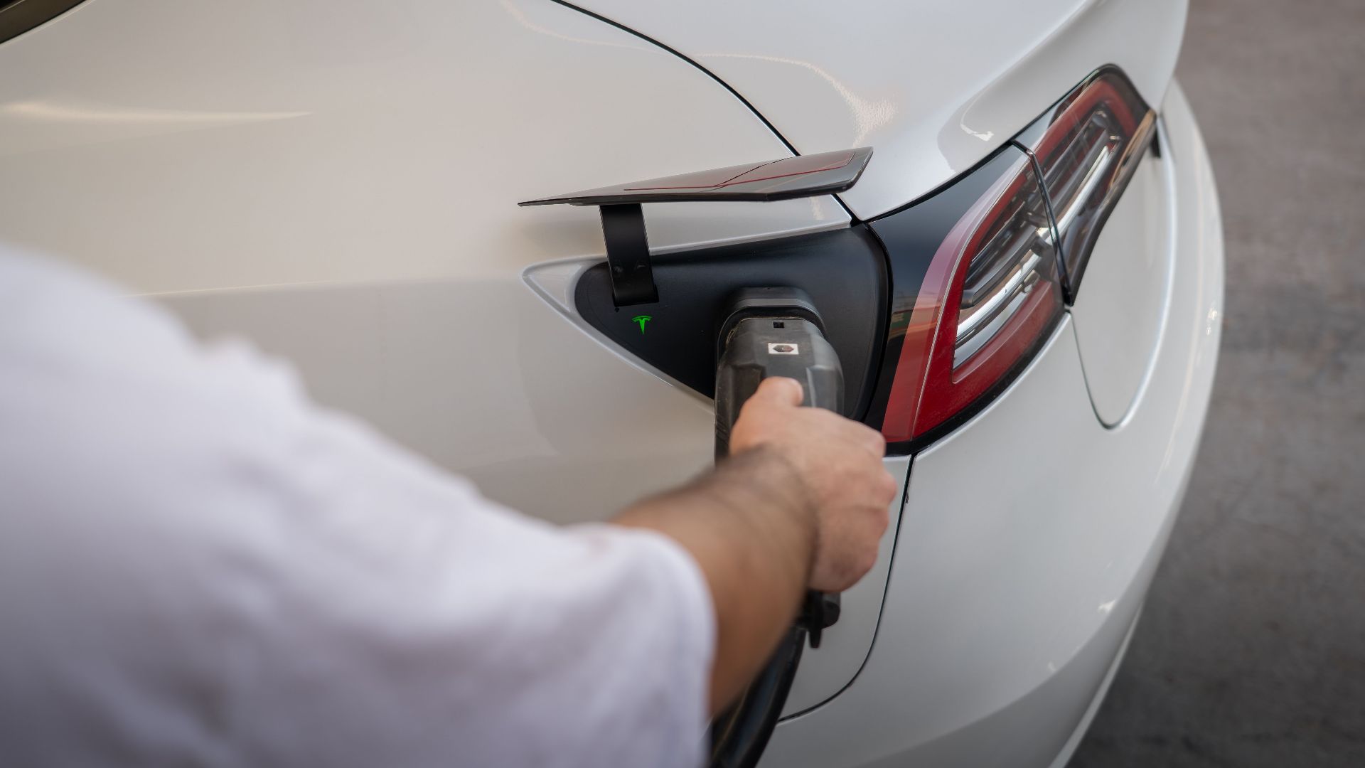 Close-up of an electric car being charged, emphasizing modern sustainable technology.