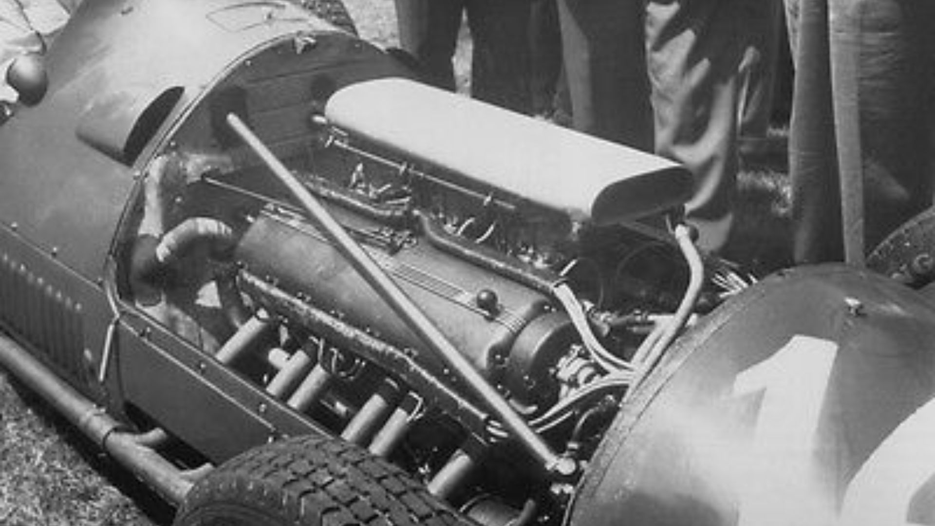 Ferrari V12 engine (Lampredi engine) in a 375 F1. The bonnet (on right) has entry #14, indicating this may be at the French GP on 1 July 1951, where entry #14 was driven by José Froilán González and the entry #14 positioned identically (slanted).