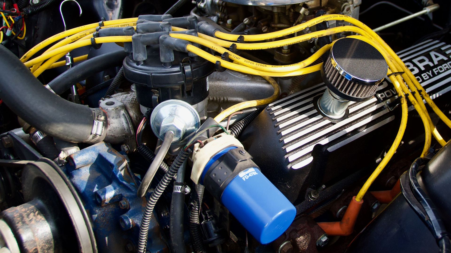 Detailed close-up of a Ford engine showcasing components and vibrant wiring.