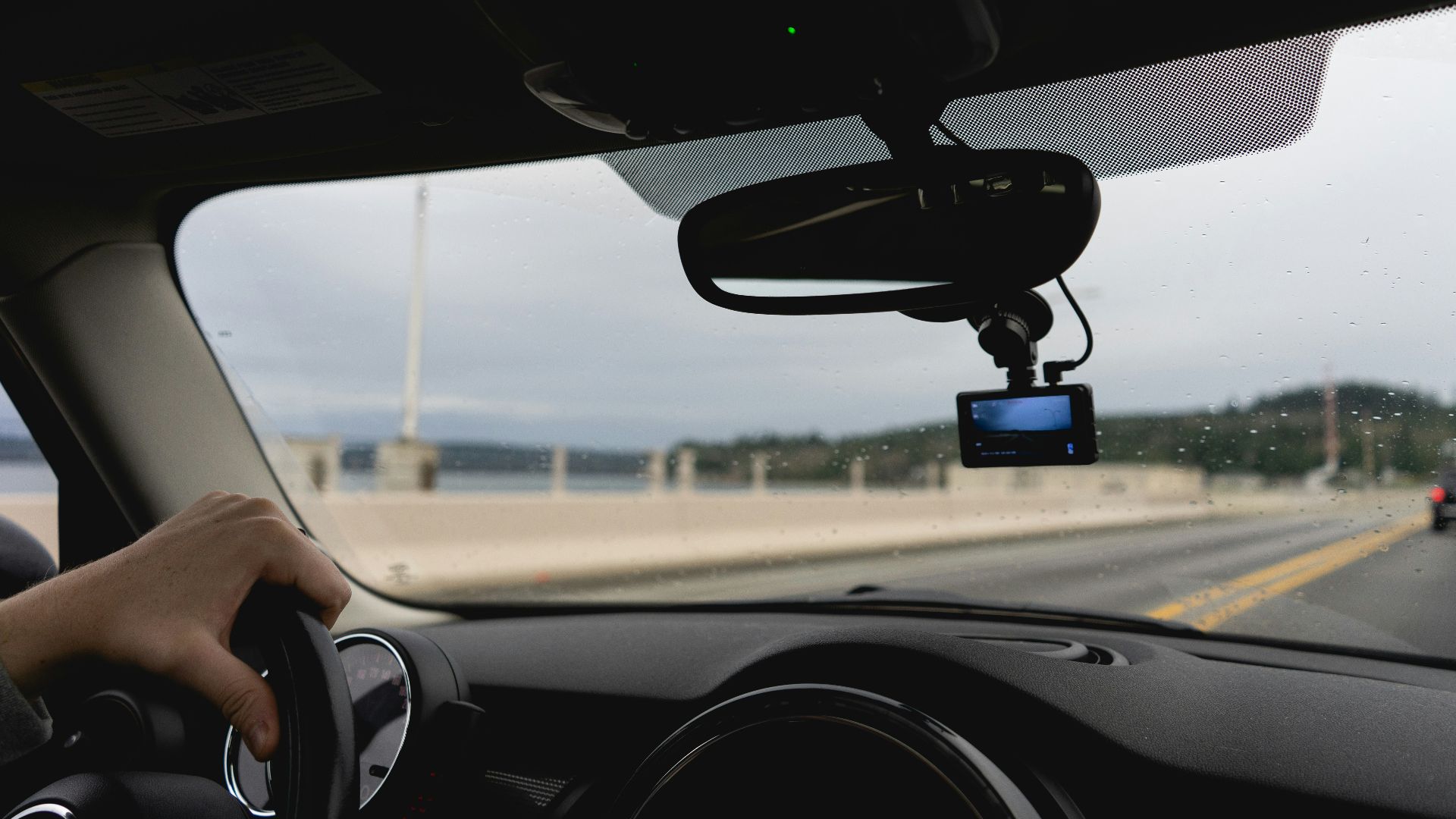 a person driving a car on a highway