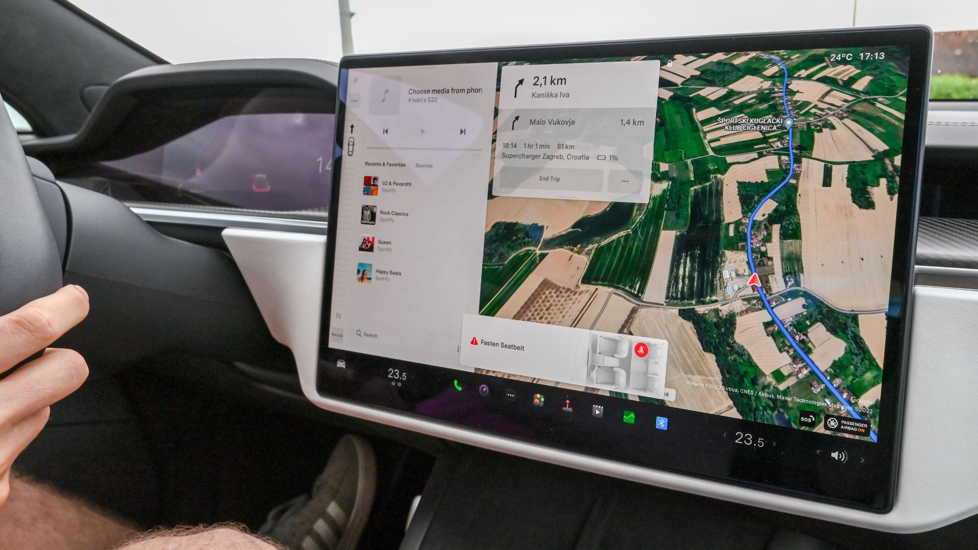 Inside view of a car with a large navigation screen and detailed digital map.