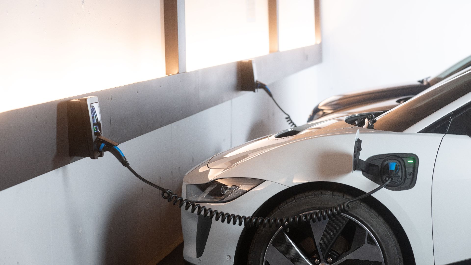 Electric car charging in a modern indoor station promoting sustainability and energy efficiency.