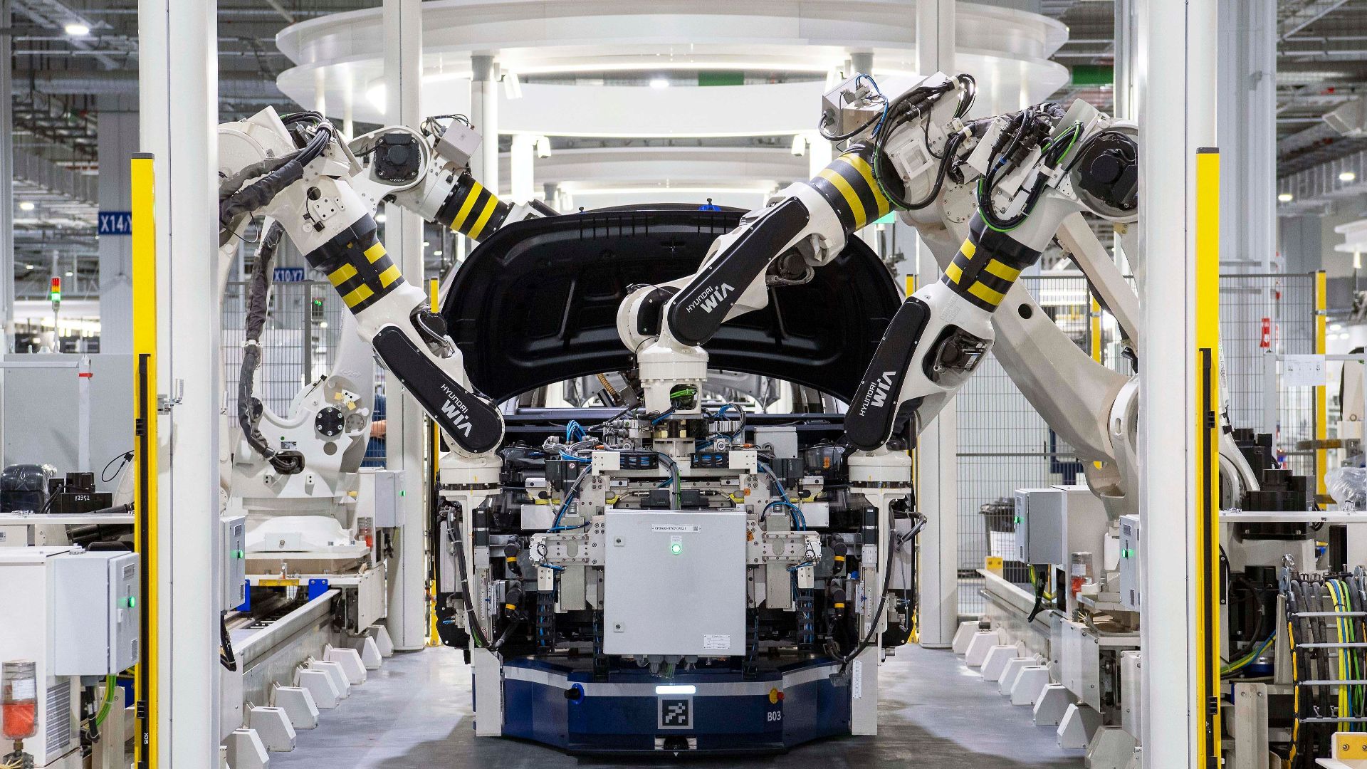 High-tech robots assembling a car in a modern factory setting, showcasing automation.