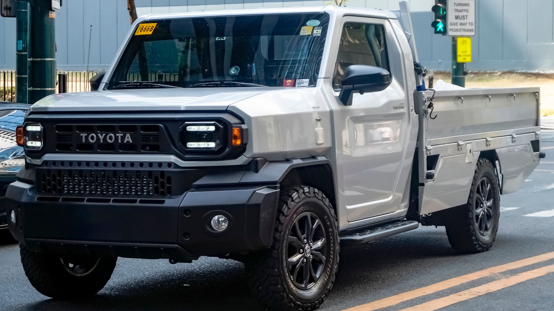 Silver Metallic Toyota Tamaraw GUN122 2.4 GL Dropside pickup truck with OEM fog lamp set and BFGoodrich all-terrain tires. Original image had plates; photoshopped it up as it was easy to on the plastic bumpers, so it did have plates before.