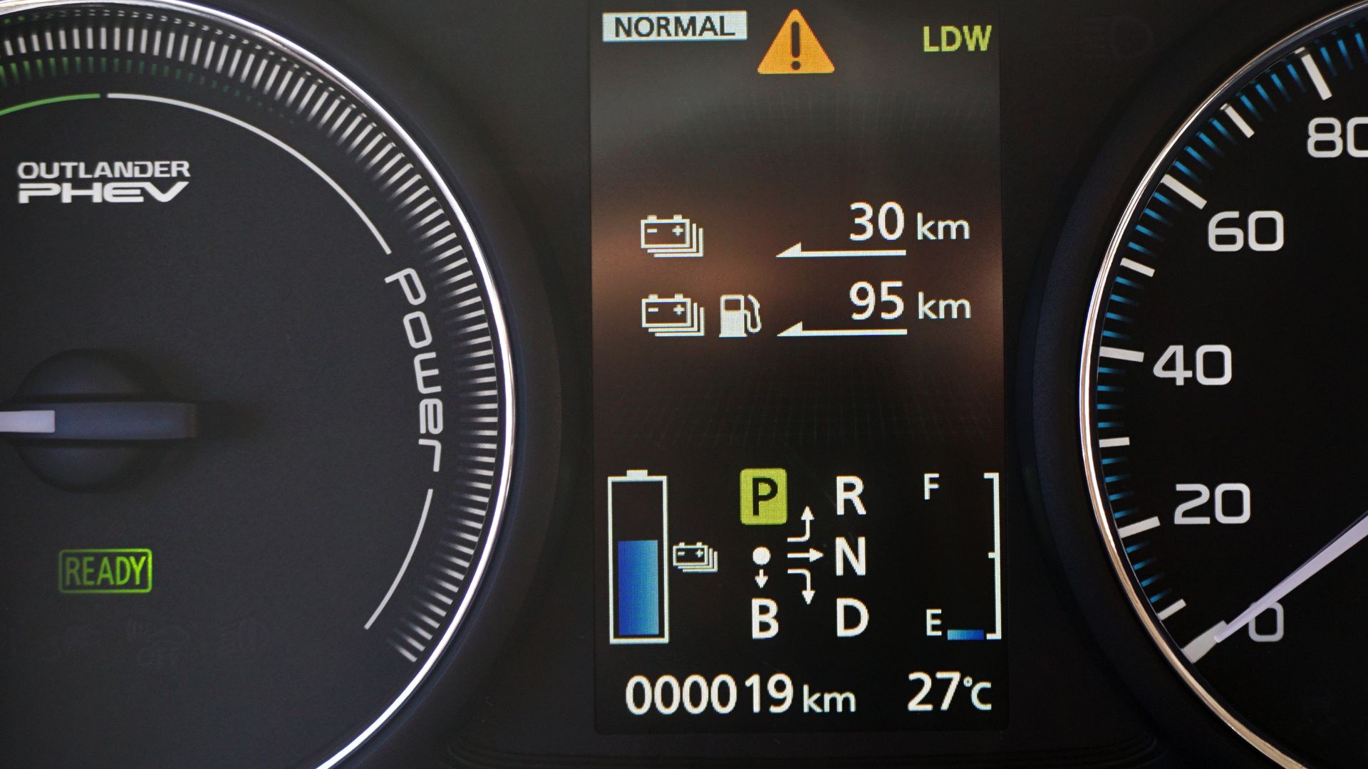 2014 Mitsubishi Outlander P-HEV: Plug-in hybrid indicator. It shows among others driving mode (Normal or Eco) and range available: EV (battery only) and hybrid (battery plus gasoline).