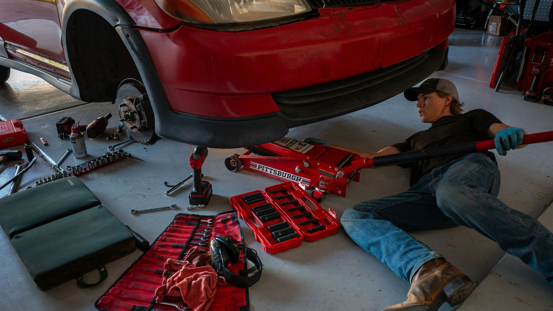 a man working on a car in a garage