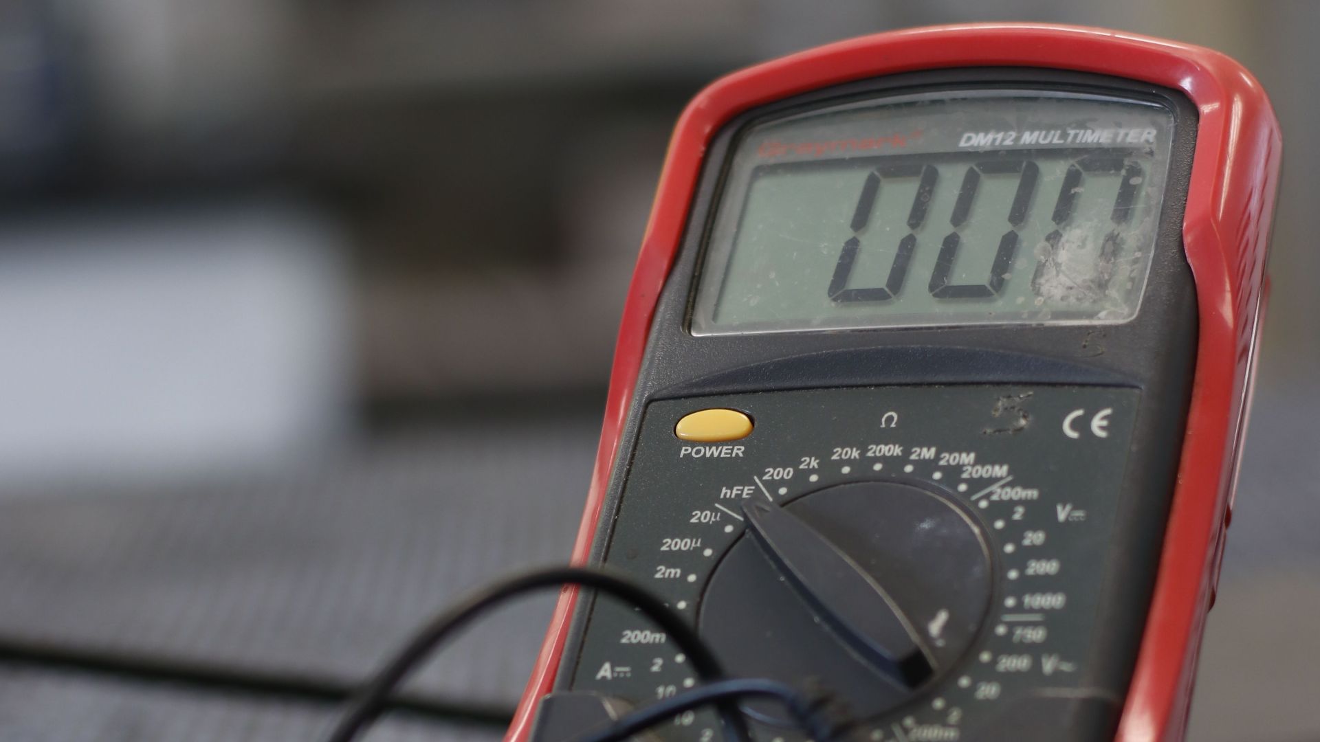 Professional multimeter with wires that combining functions of voltmeter ammeter ohmmeter placed on floor