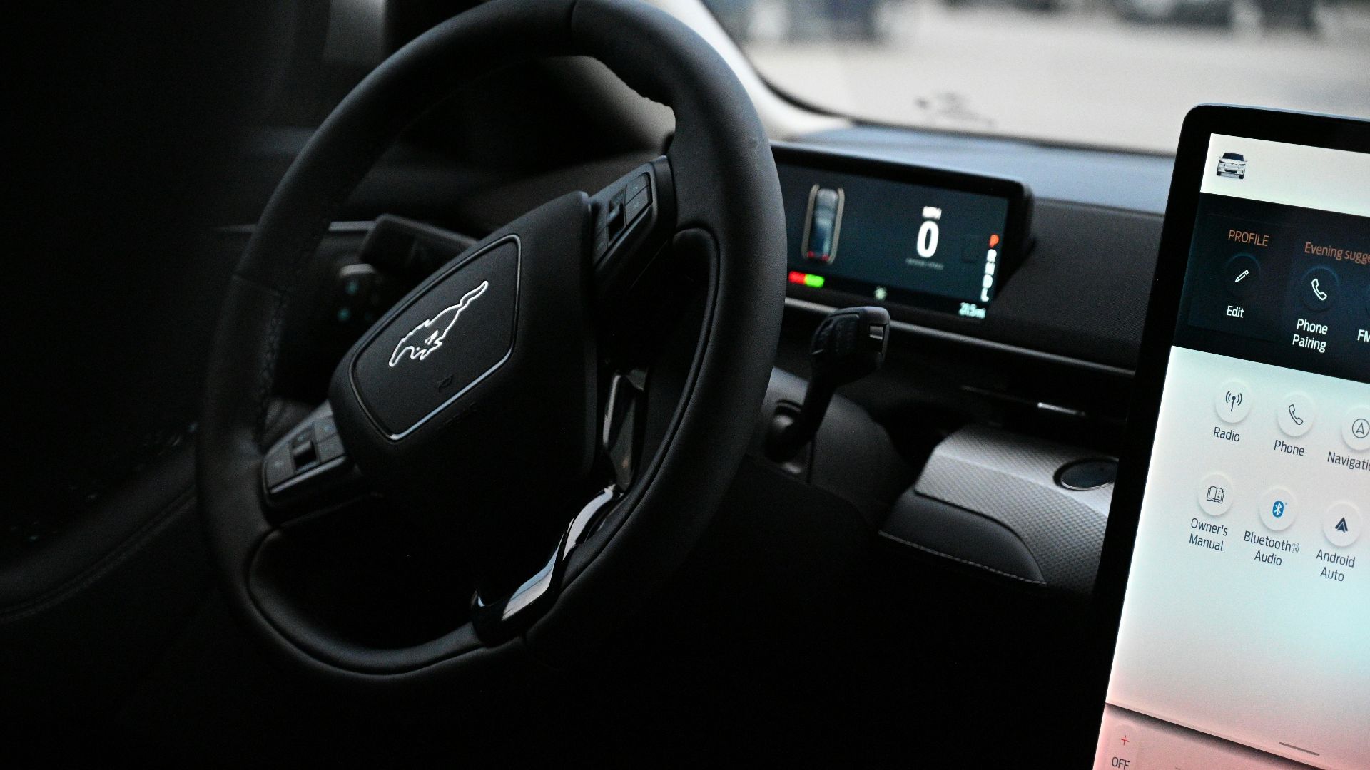 a car dashboard with a touch screen and a steering wheel