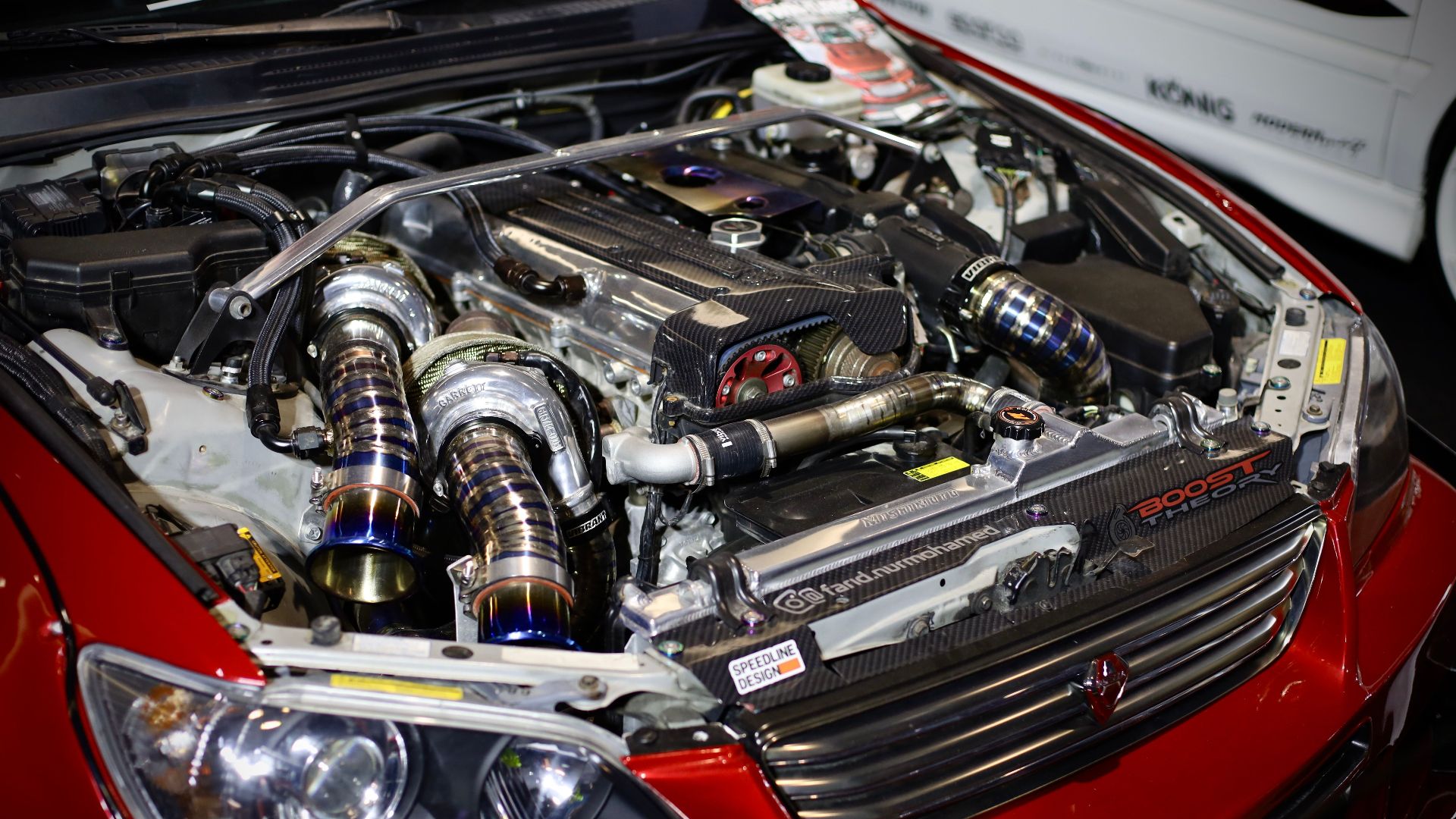 High-performance red car engine with visible turbochargers and enhancements.