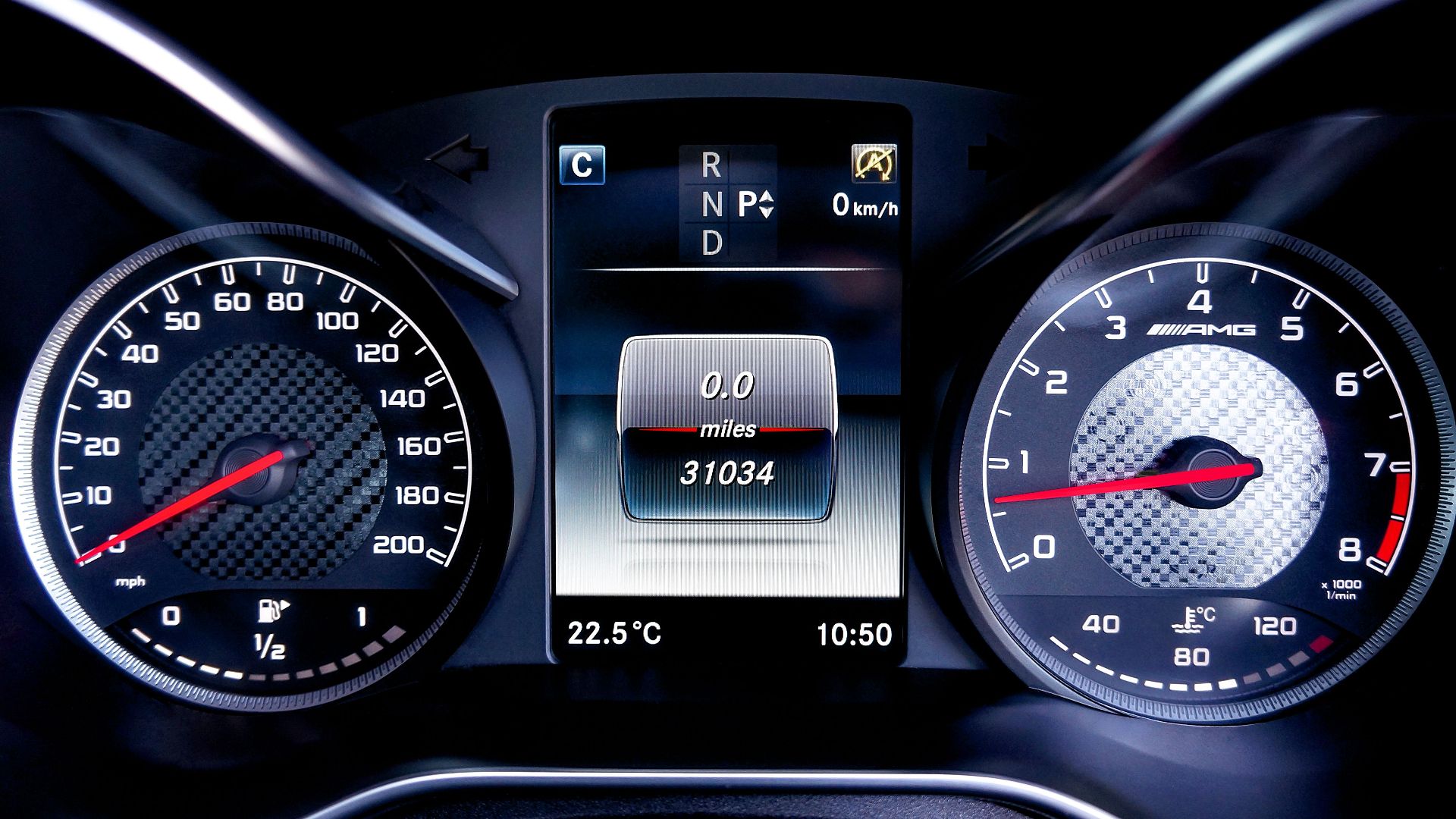 Close-up of a modern car dashboard showing speedometers and digital display in a luxury vehicle.