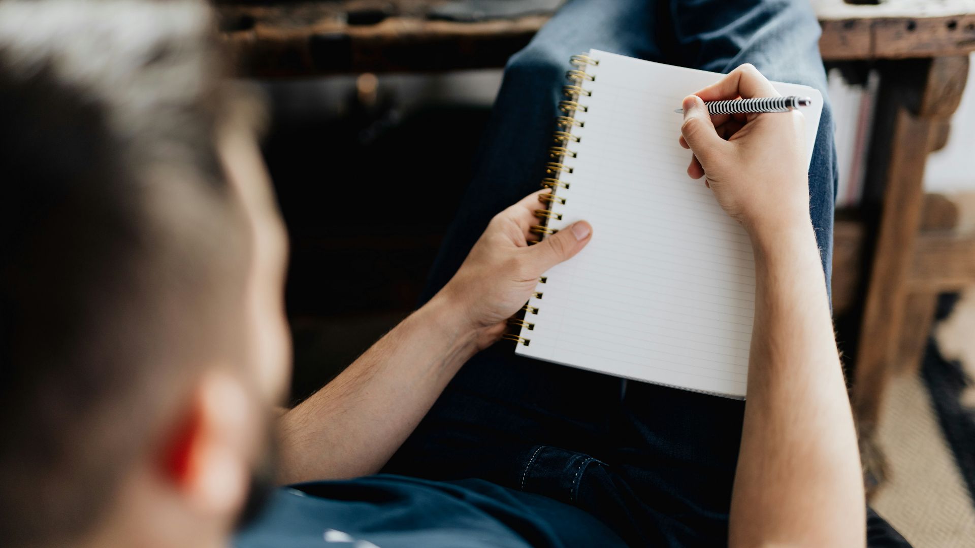 a person writing on a piece of paper