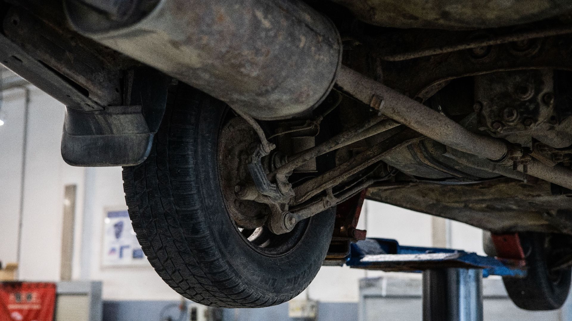 Close-up of car's undercarriage in a service station for repair and maintenance.