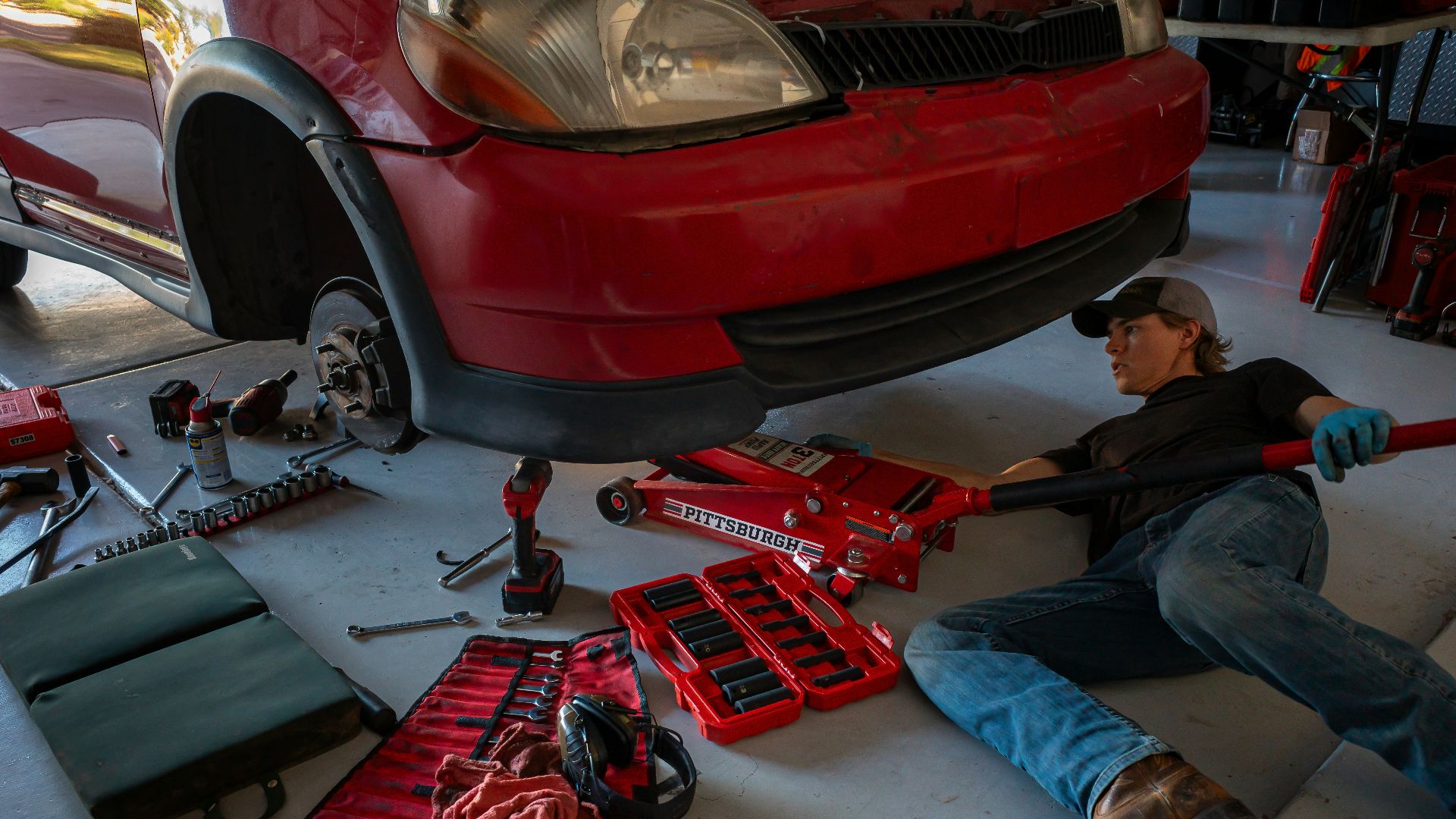 a man working on a car in a garage