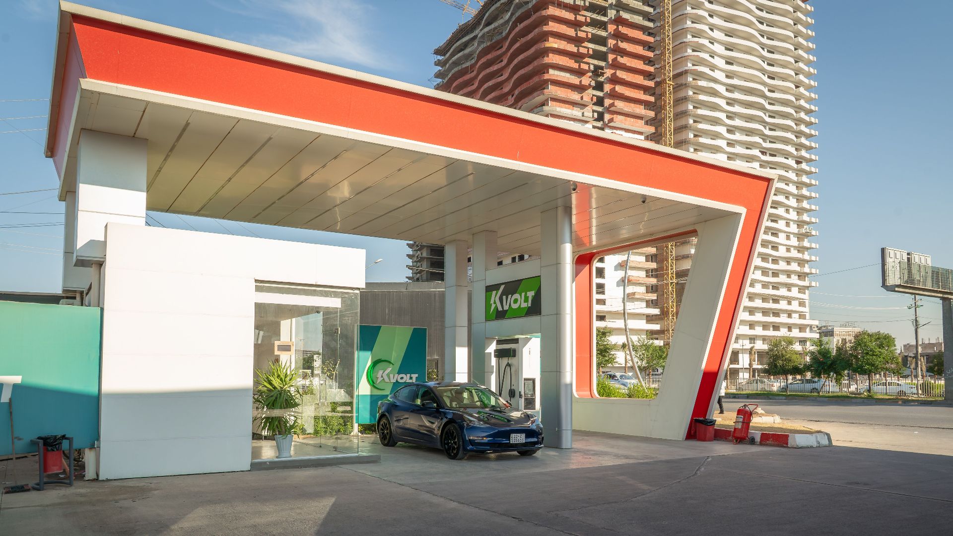 Electric vehicle at a modern charging station in an urban setting, promoting sustainability.