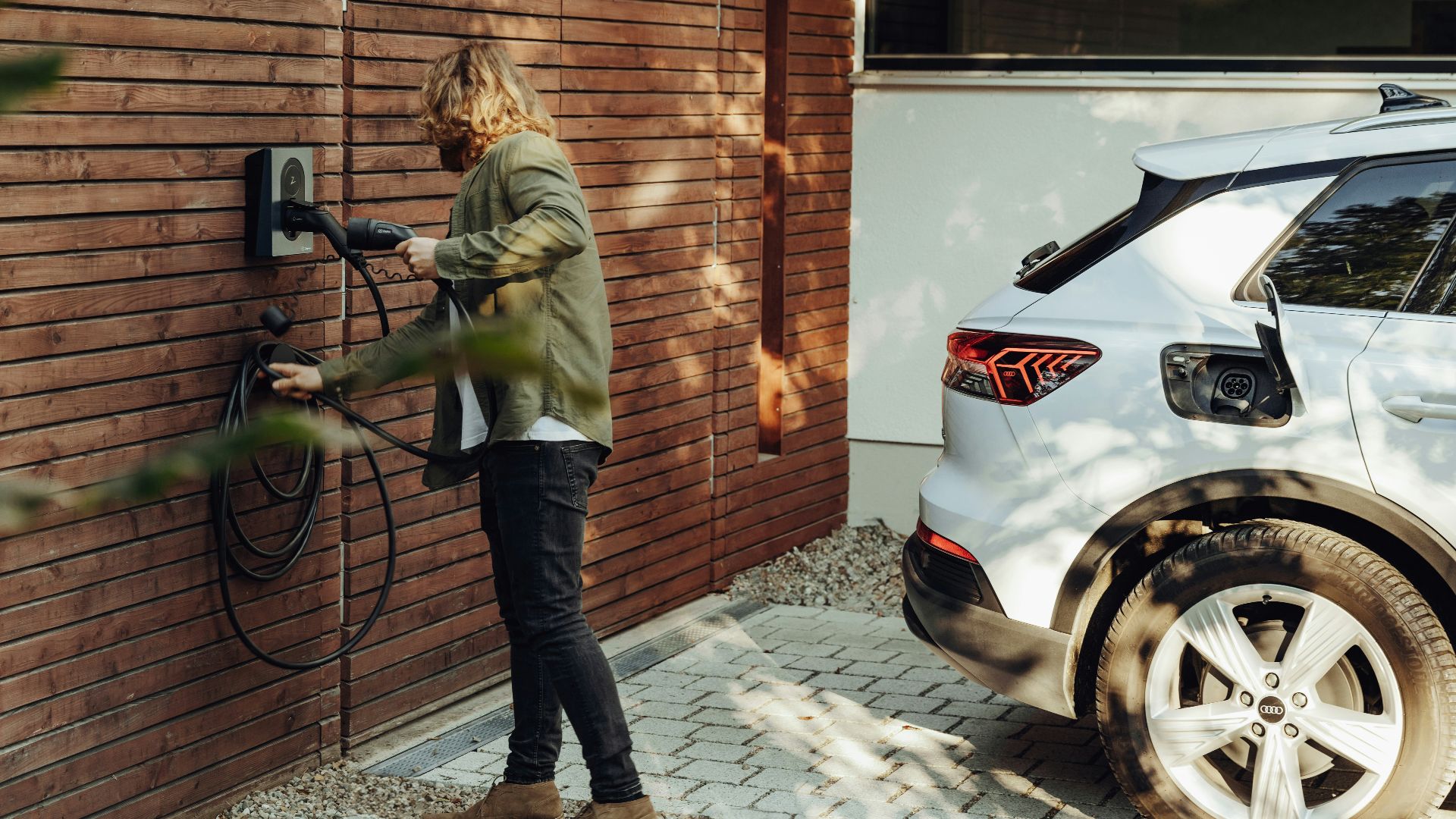 a woman is using a power washer on a brick wall