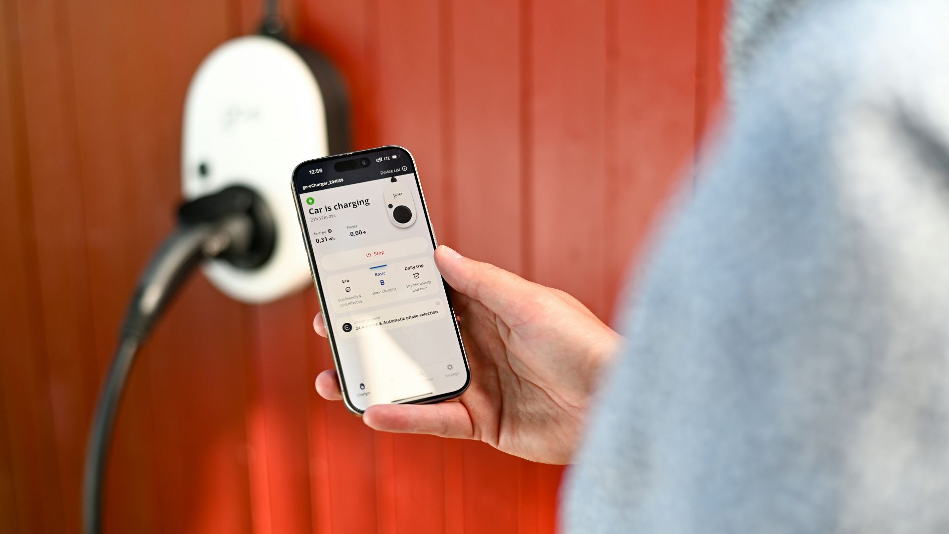 Person uses phone to control electric vehicle charger