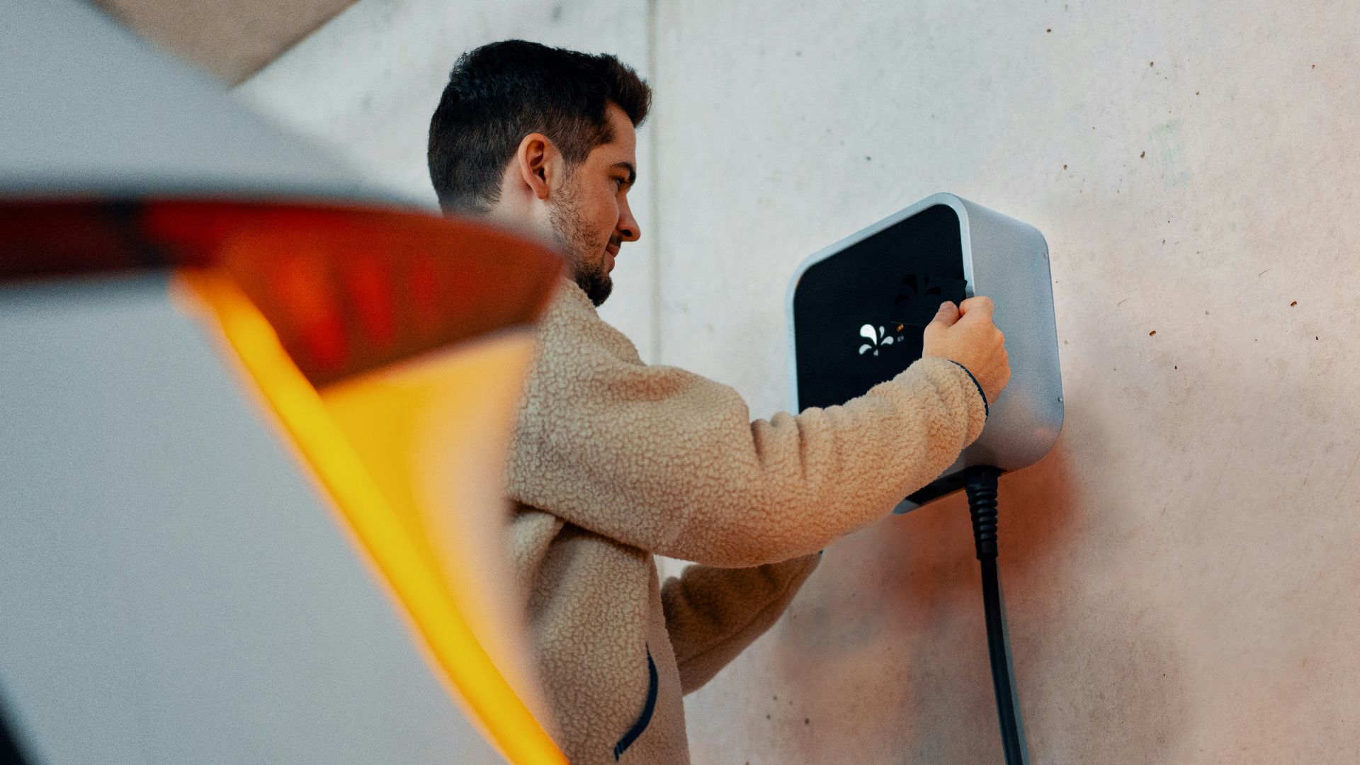 A man is plugging in a car charger
